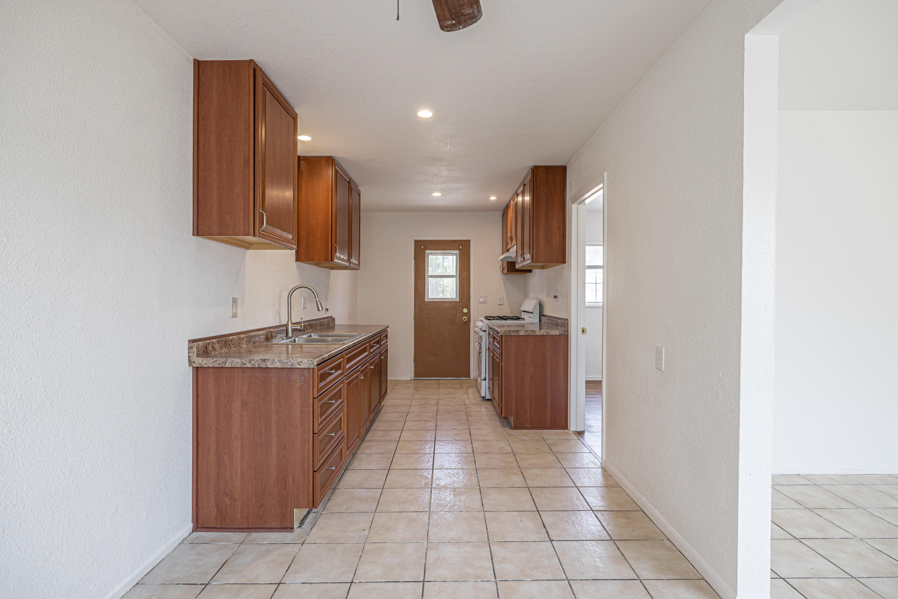44272 Glenraven Road Lancaster, CA 93535 - Photo 7 of 21 a kitchen with stainless steel appliances granite countertop a refrigerator and a sink