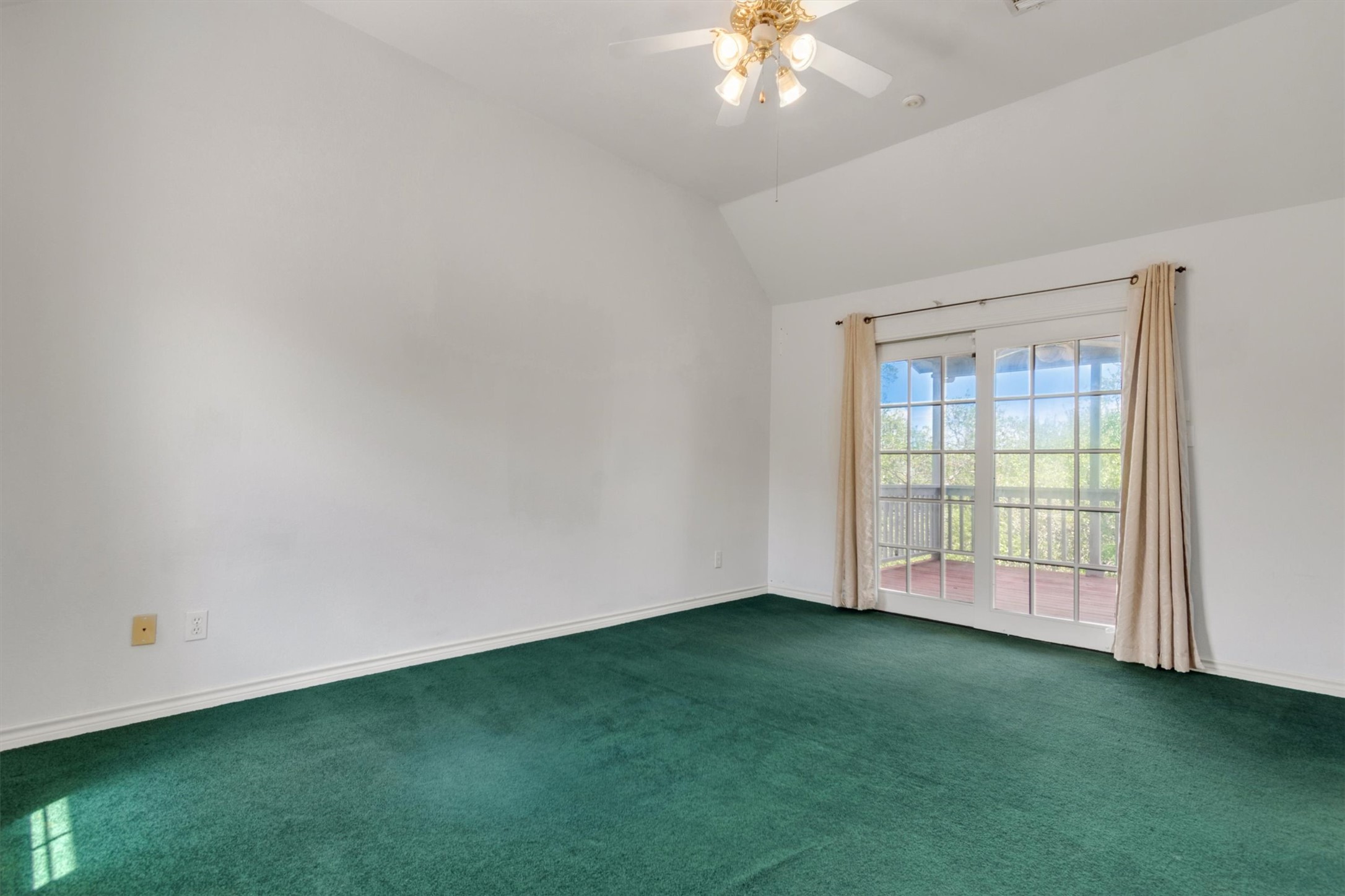 1207 Orlando Road Austin, TX 78733 - Photo 13 of 30 Spacious room featuring vaulted ceilings, a ceiling fan with integrated lighting, and carpet flooring