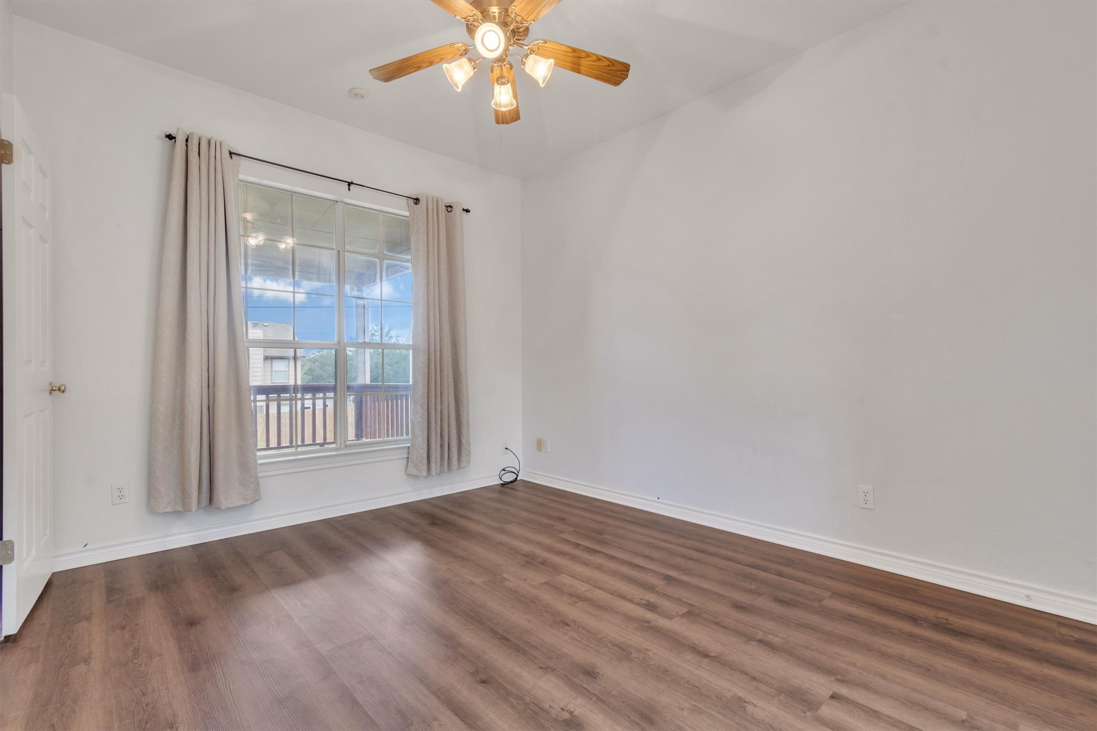 1207 Orlando Road Austin, TX 78733 - Photo 19 of 30 Spacious room featuring wood-finish flooring and a central ceiling fan with integrated lighting