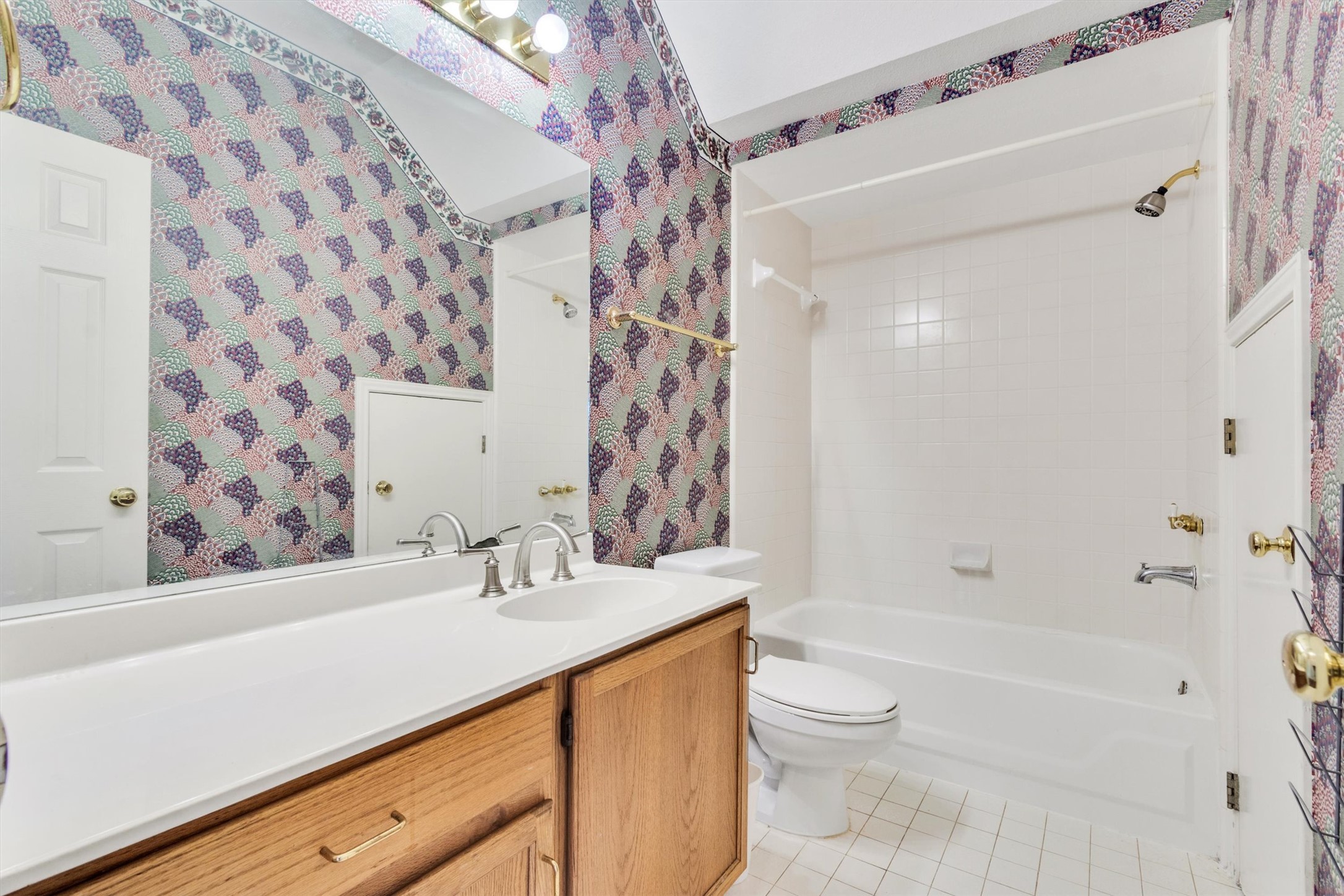 1207 Orlando Road Austin, TX 78733 - Photo 20 of 30 Full bathroom featuring a single vanity with wood-finish cabinetry, a white countertop, and a built-in sink