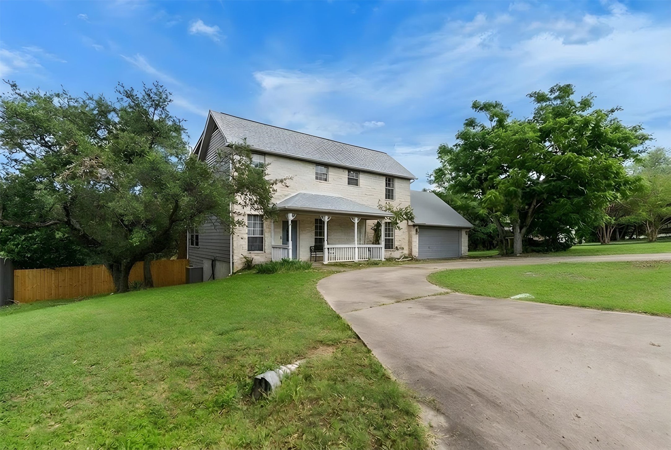 1207 Orlando Road Austin, TX 78733 - Photo 2 of 30 Two-story residence featuring a gray shingle roof and a covered front porch with white railings
