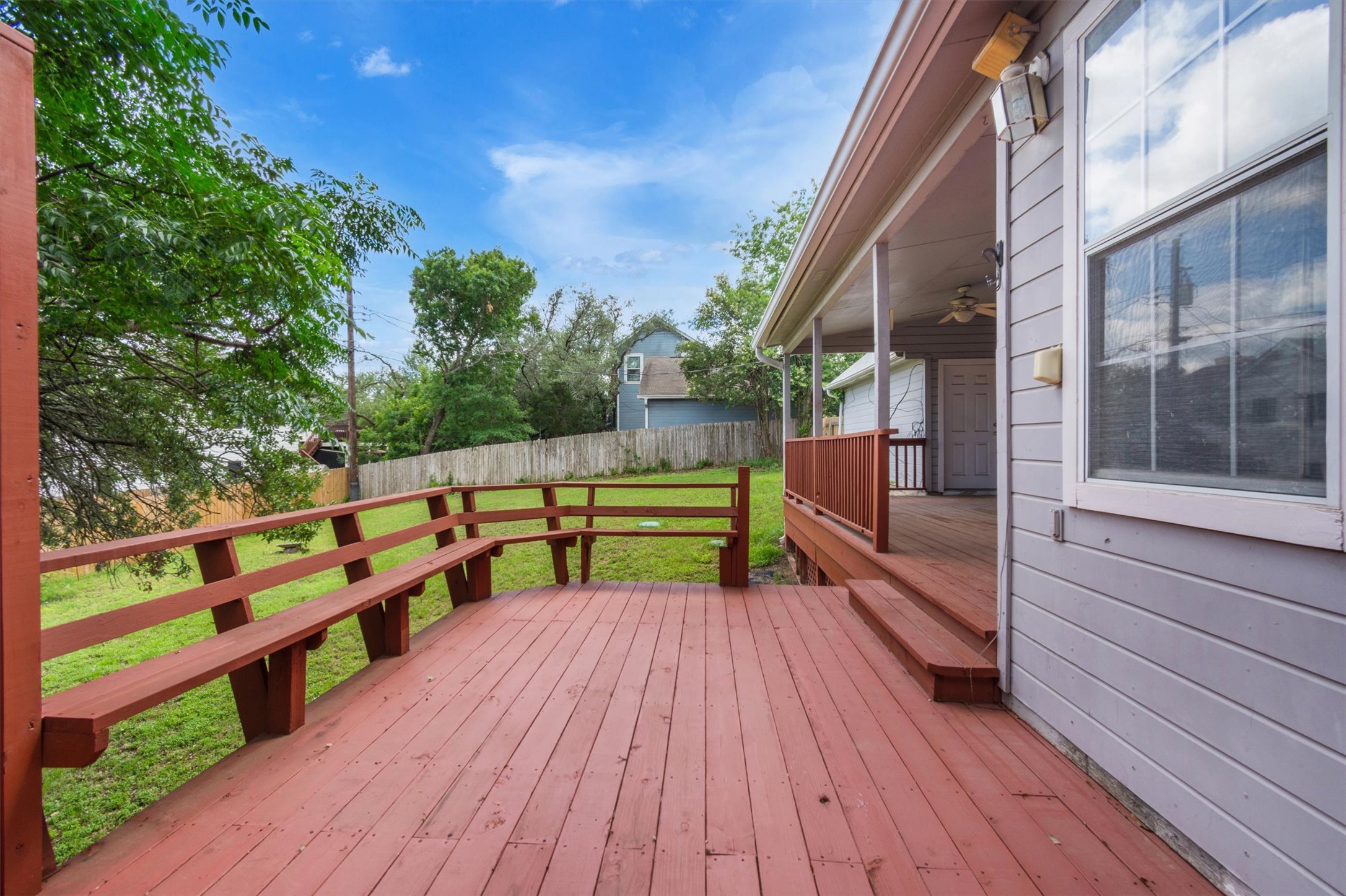 1207 Orlando Road Austin, TX 78733 - Photo 26 of 30 Expansive outdoor deck with built-in bench seating, wood railing, and direct access to a covered porch