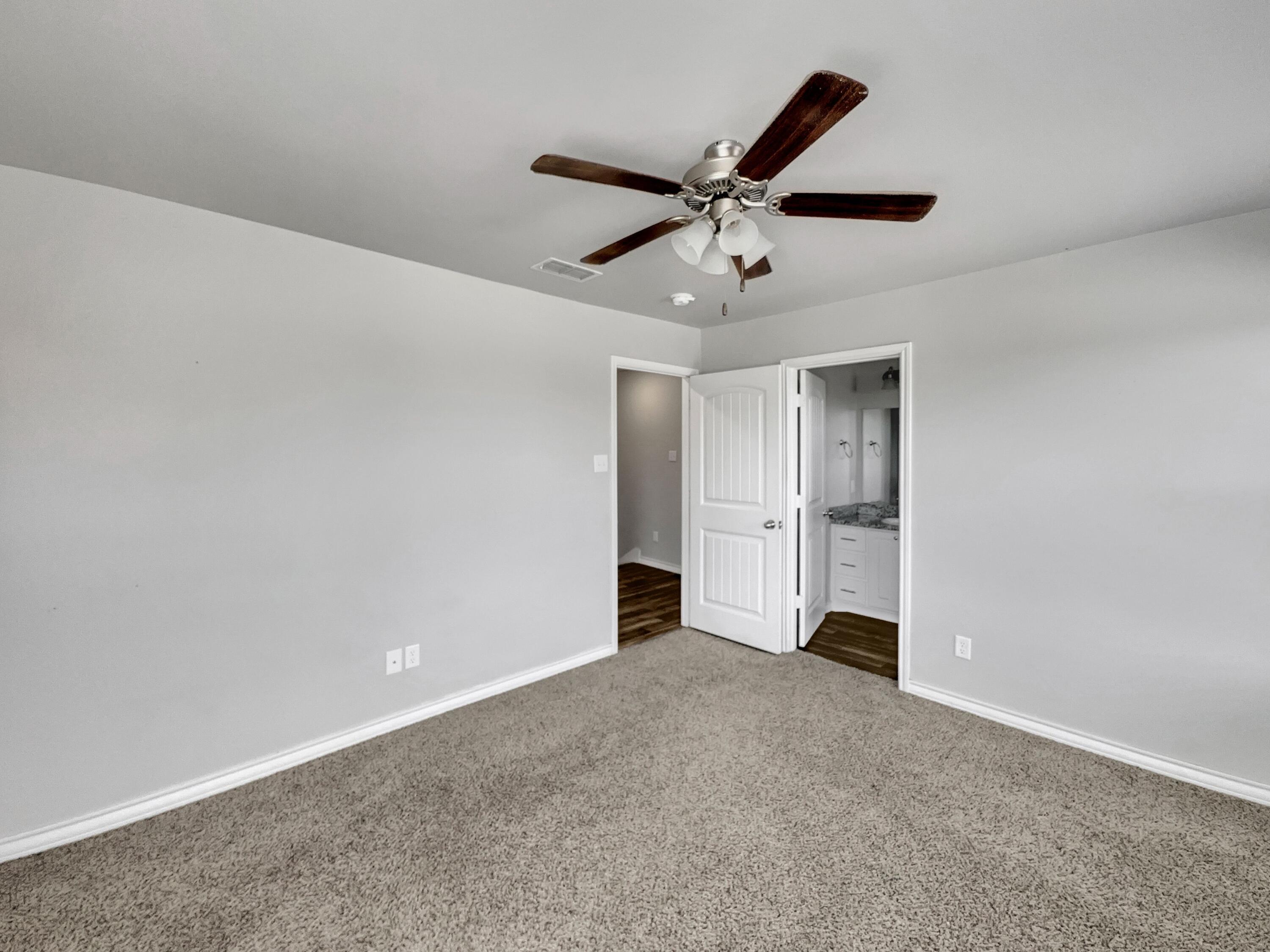 6040 24th Street, Unit 41 Lubbock, TX 79407 - Photo 12 of 12 an empty room with closet and fan