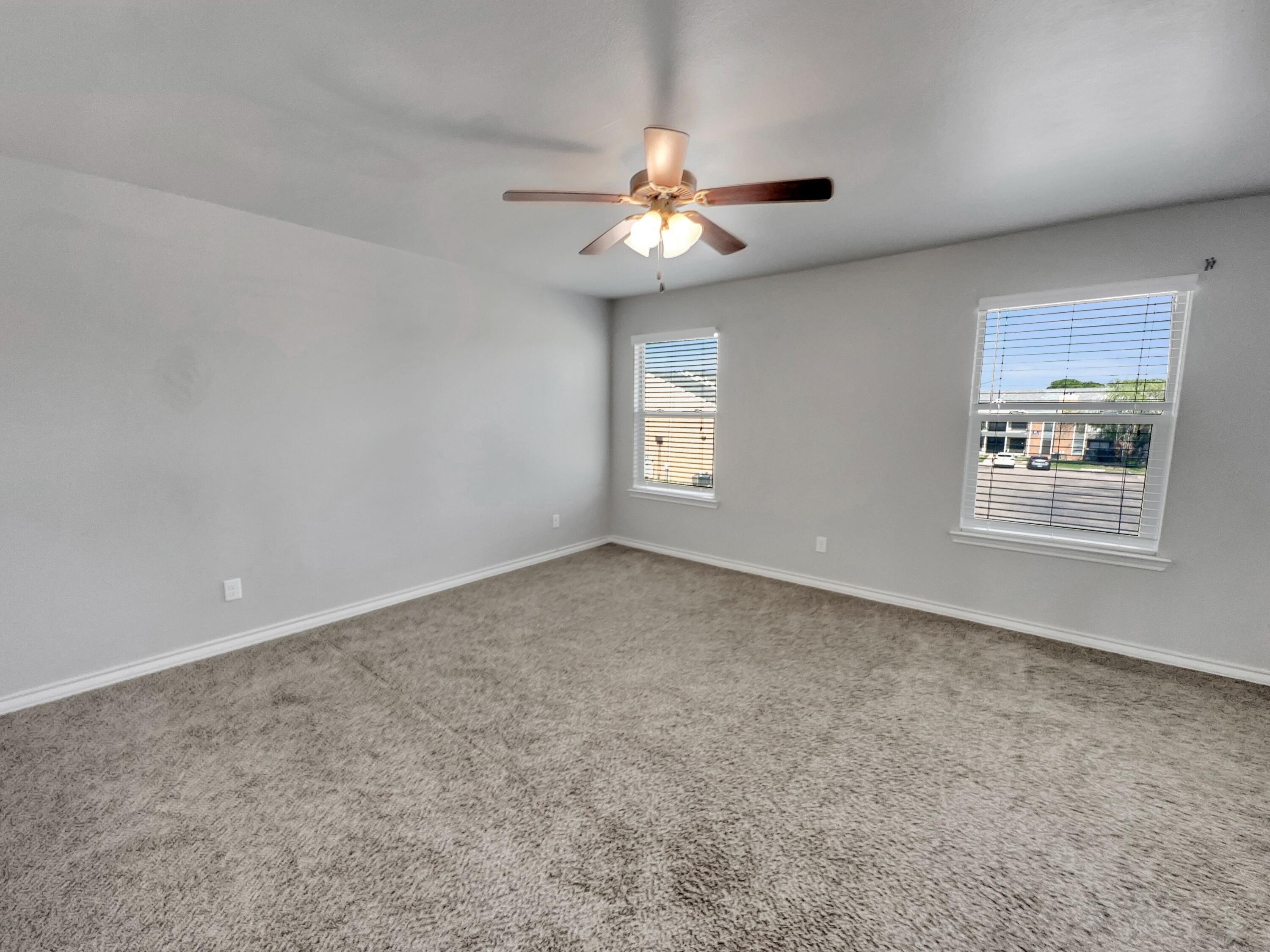 6040 24th Street, Unit 41 Lubbock, TX 79407 - Photo 5 of 12 an empty room with windows and fan