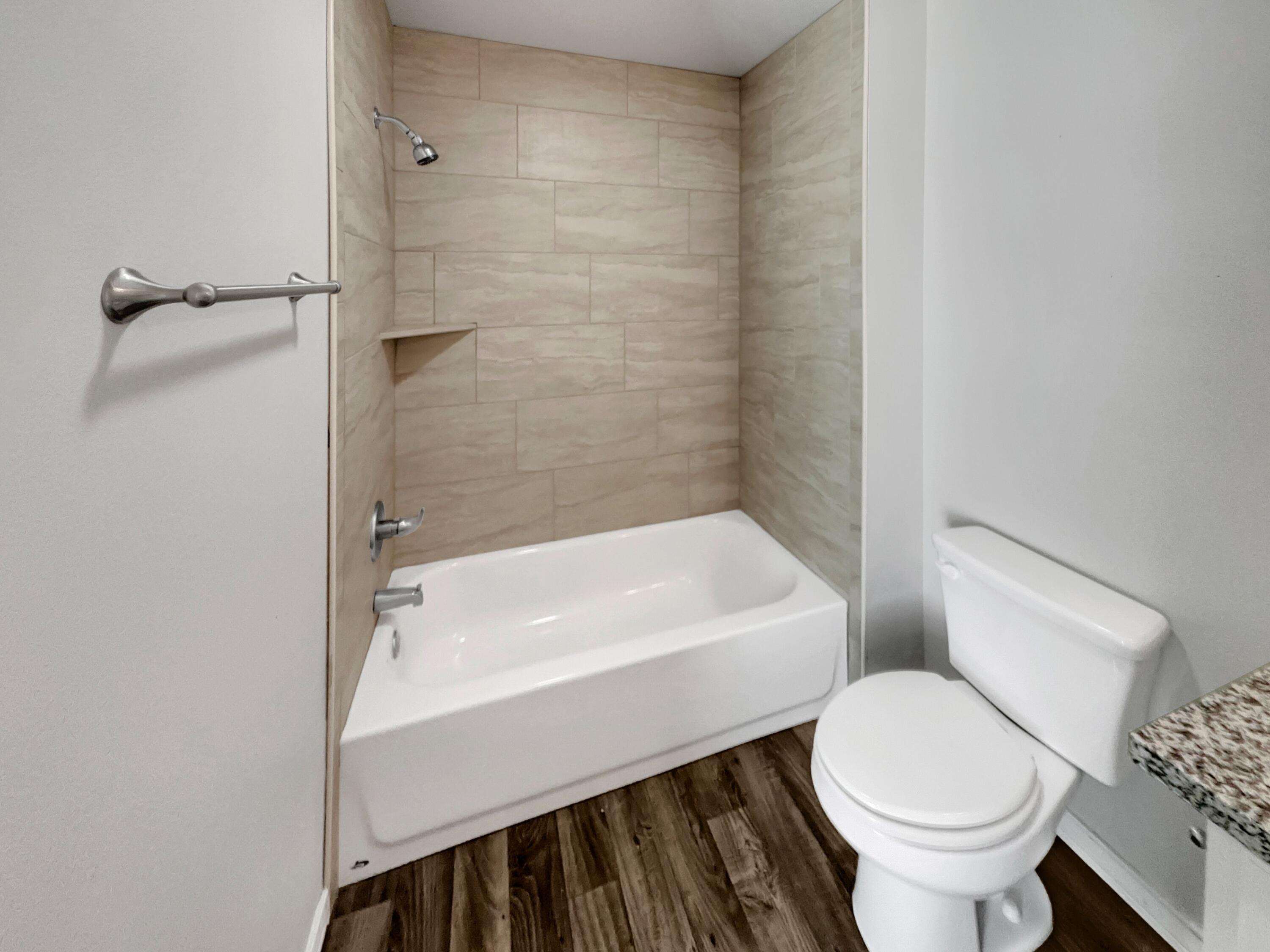 6040 24th Street, Unit 41 Lubbock, TX 79407 - Photo 6 of 12 a bathroom with a sink a toilet and a bathtub