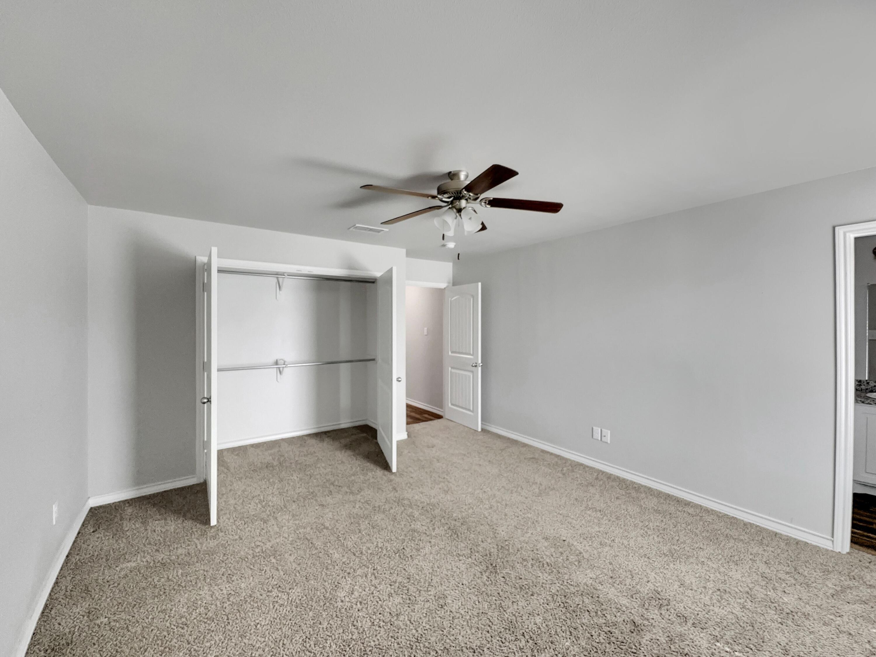 6040 24th Street, Unit 41 Lubbock, TX 79407 - Photo 8 of 12 a view of an empty room with a ceiling fan