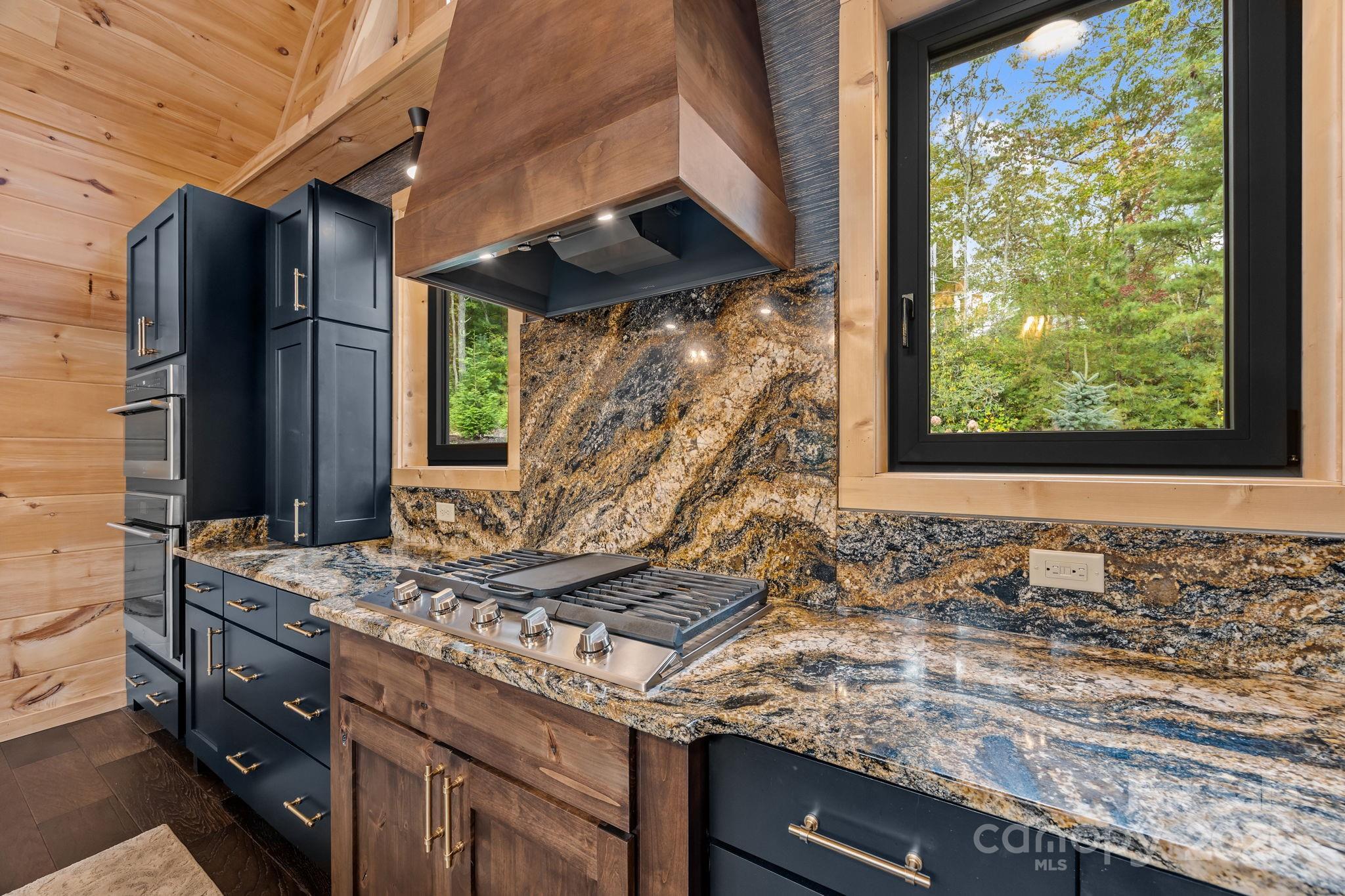 91 Boone Cove Road Zirconia, NC 28790 - Photo 12 of 48 a kitchen with a granite countertop sink and a window