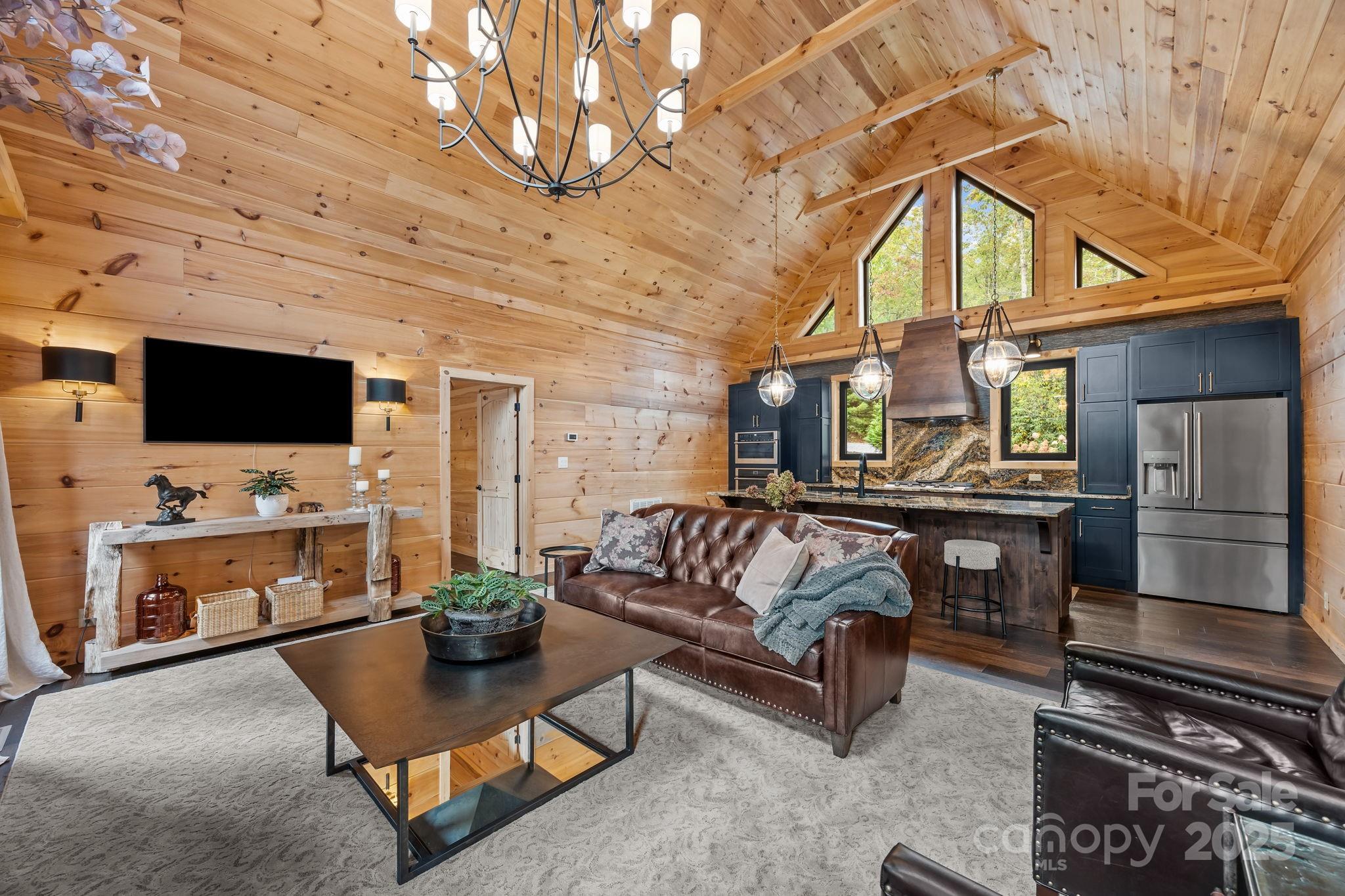 91 Boone Cove Road Zirconia, NC 28790 - Photo 14 of 48 a living room with furniture and a flat screen tv
