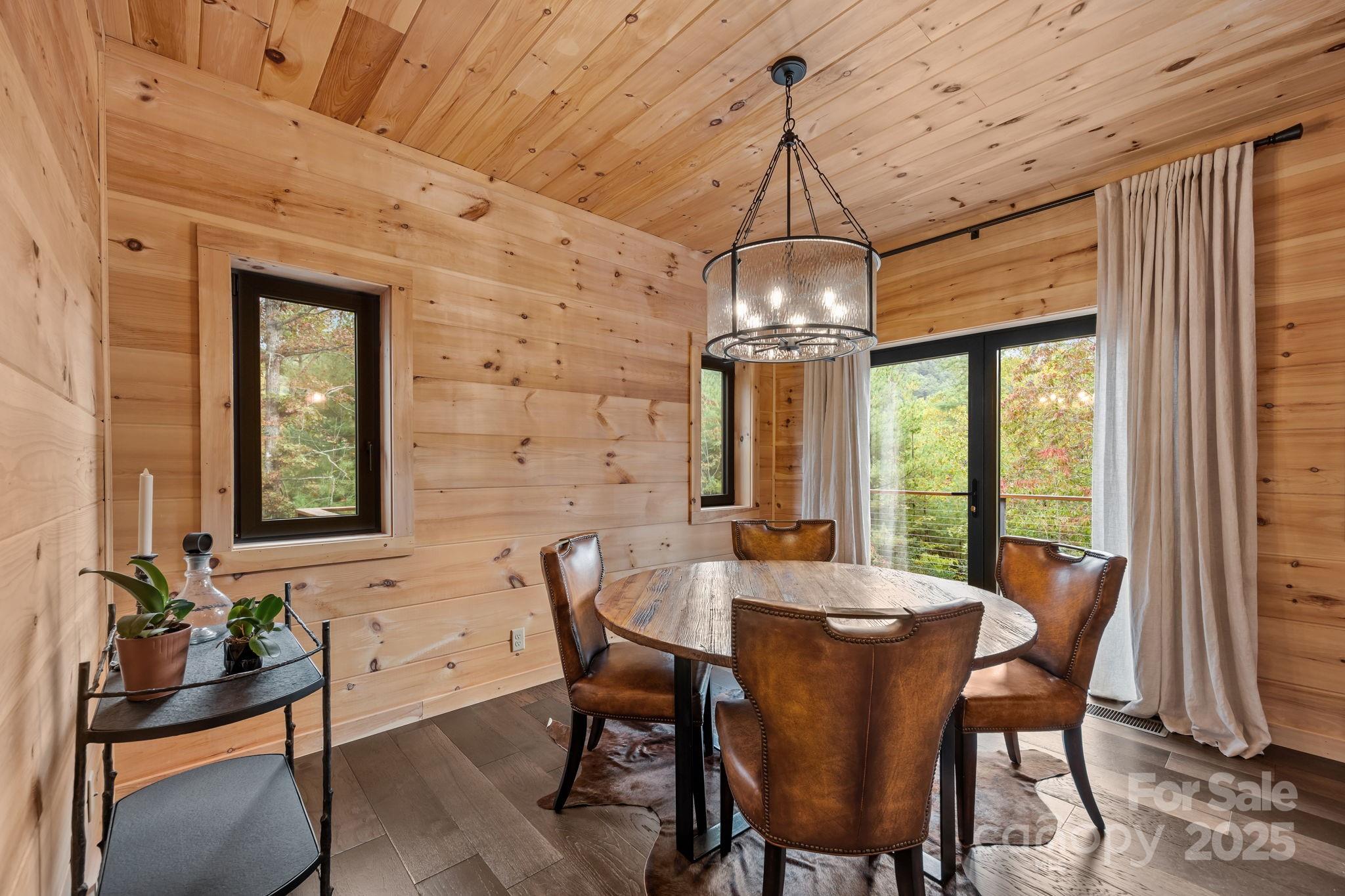 91 Boone Cove Road Zirconia, NC 28790 - Photo 15 of 48 a view of a dining room with furniture window and outside view