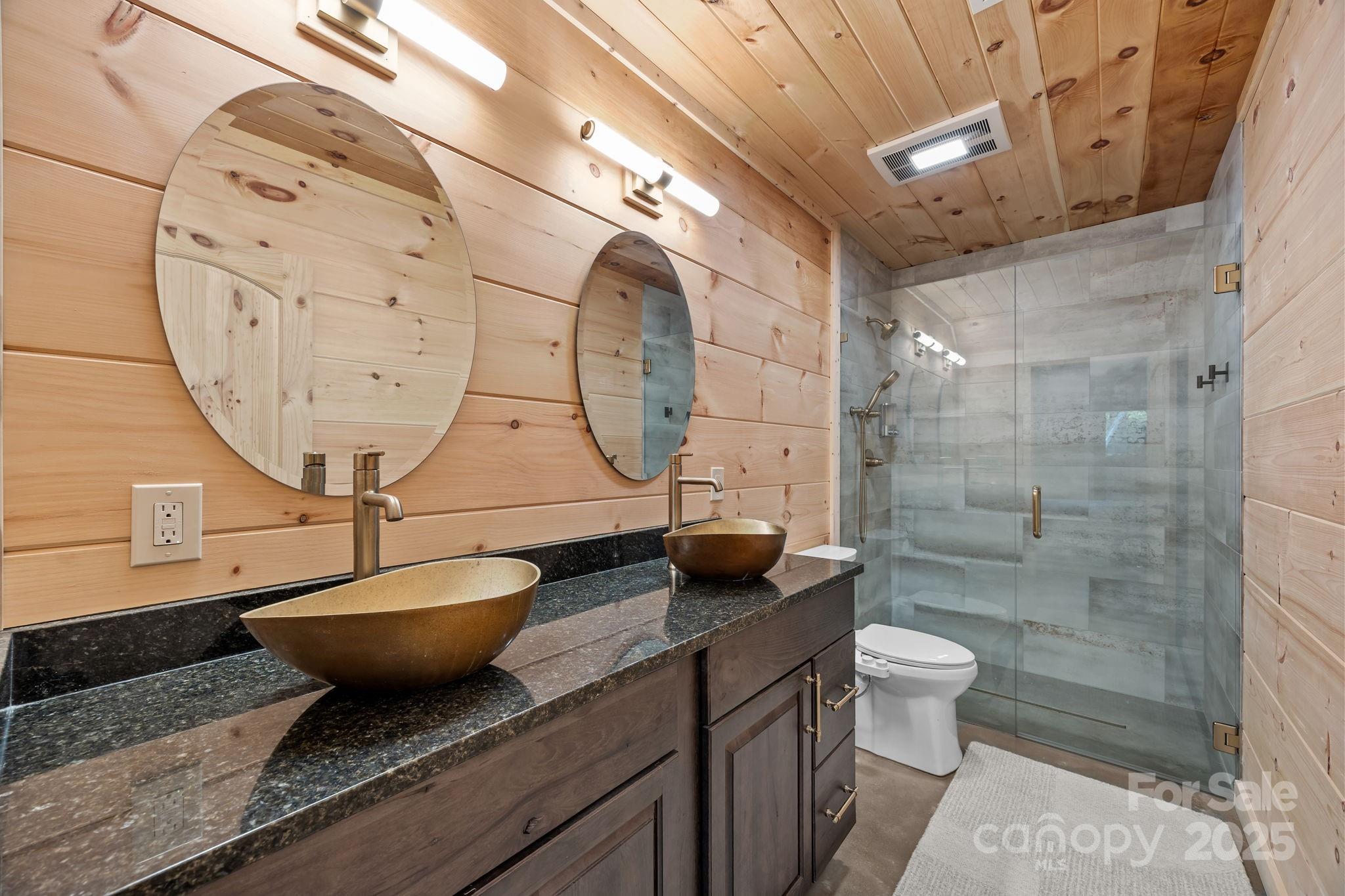 91 Boone Cove Road Zirconia, NC 28790 - Photo 21 of 48 a bathroom with a granite countertop sink a toilet and shower