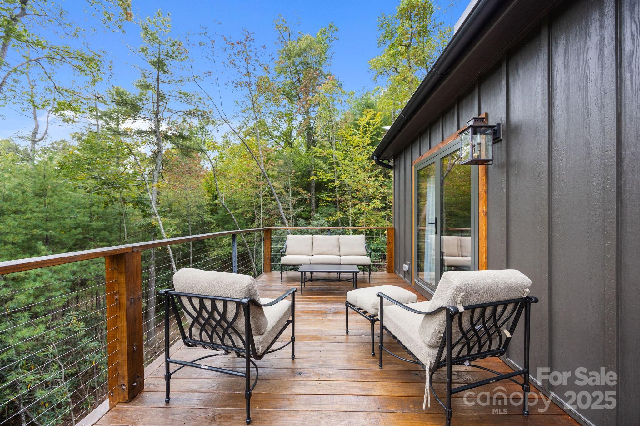 91 Boone Cove Road Zirconia, NC 28790 - Photo 23 of 48 a view of balcony with furniture and outdoor space