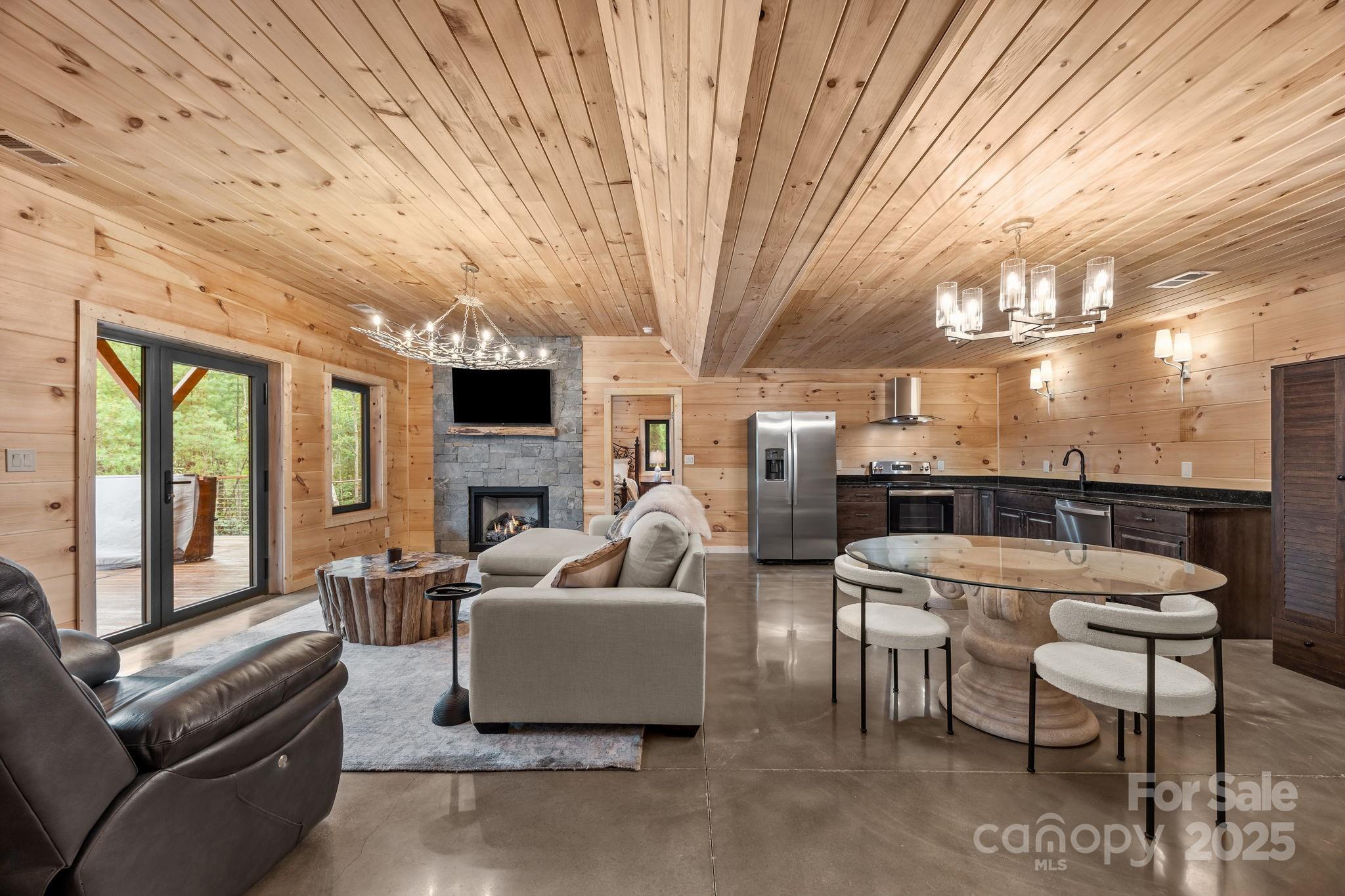 91 Boone Cove Road Zirconia, NC 28790 - Photo 25 of 48 a outdoor space with couches a barbecue grill a dining table and chairs with outer view
