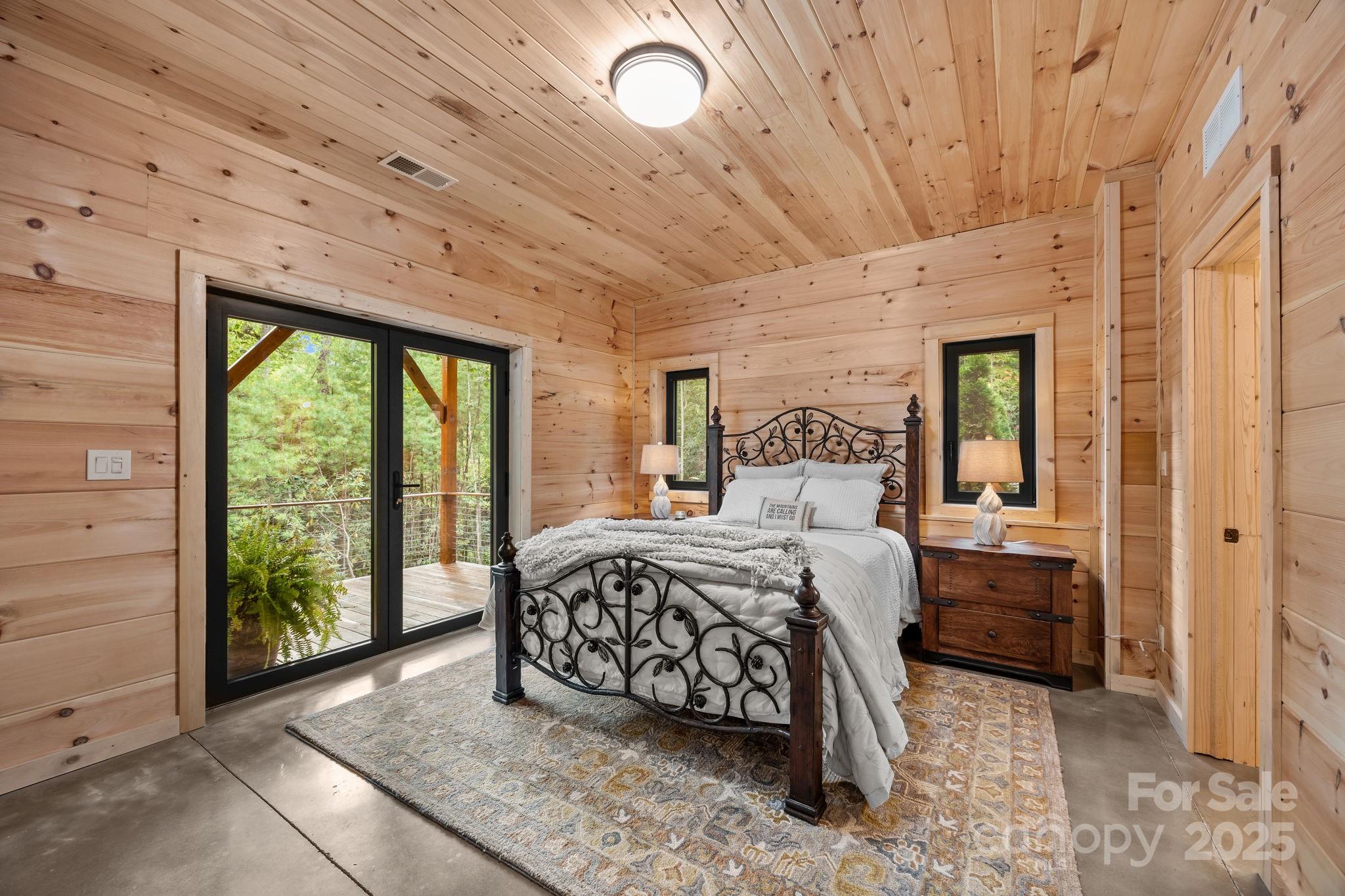 91 Boone Cove Road Zirconia, NC 28790 - Photo 30 of 48 a bedroom with a bed and large window