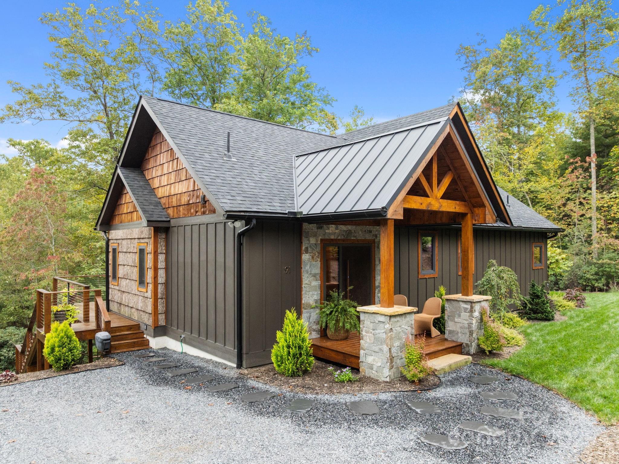 91 Boone Cove Road Zirconia, NC 28790 - Photo 3 of 48 a view of small house with yard and sitting area