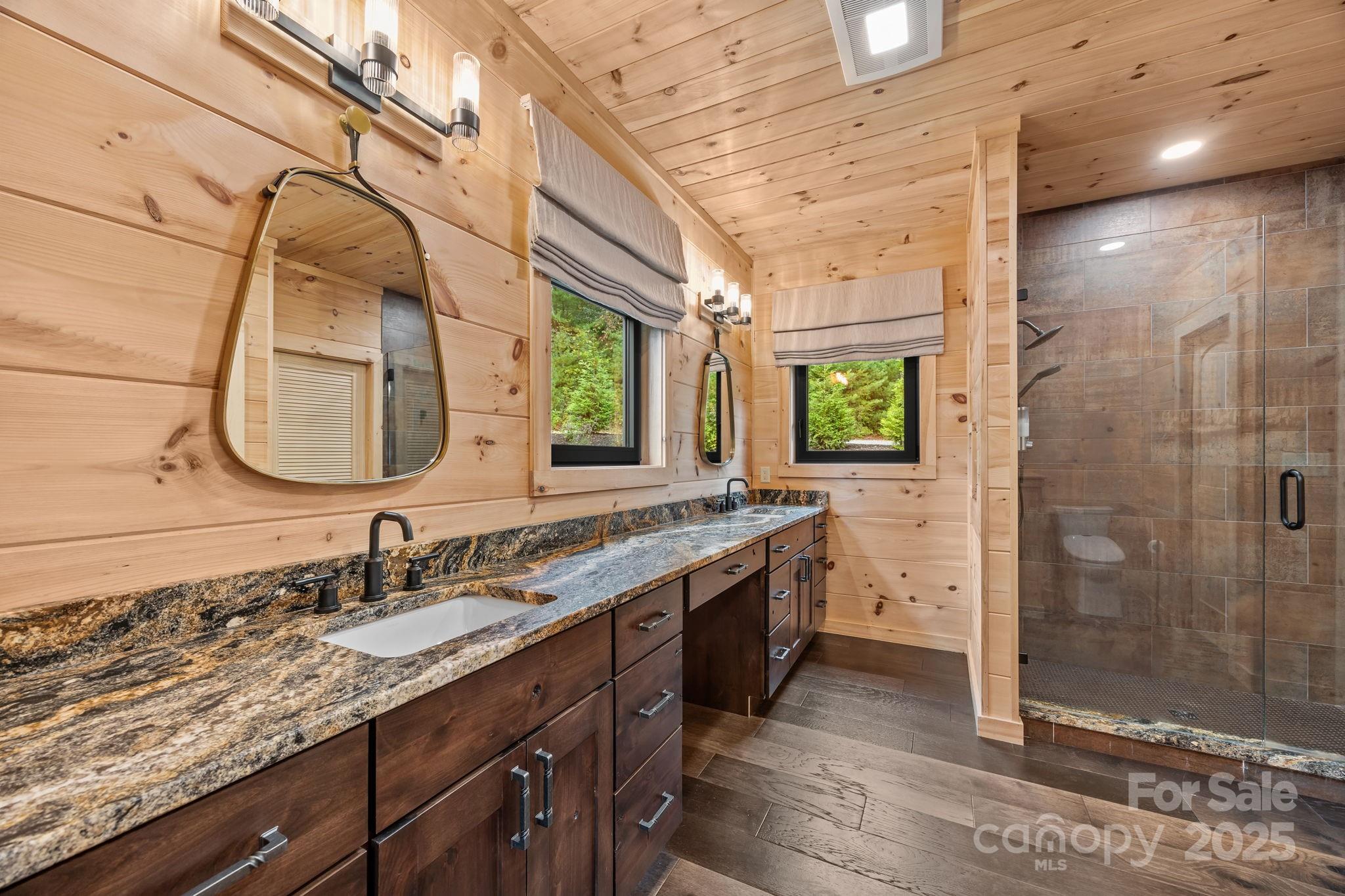 91 Boone Cove Road Zirconia, NC 28790 - Photo 31 of 48 a bathroom with a granite countertop sink mirror and double