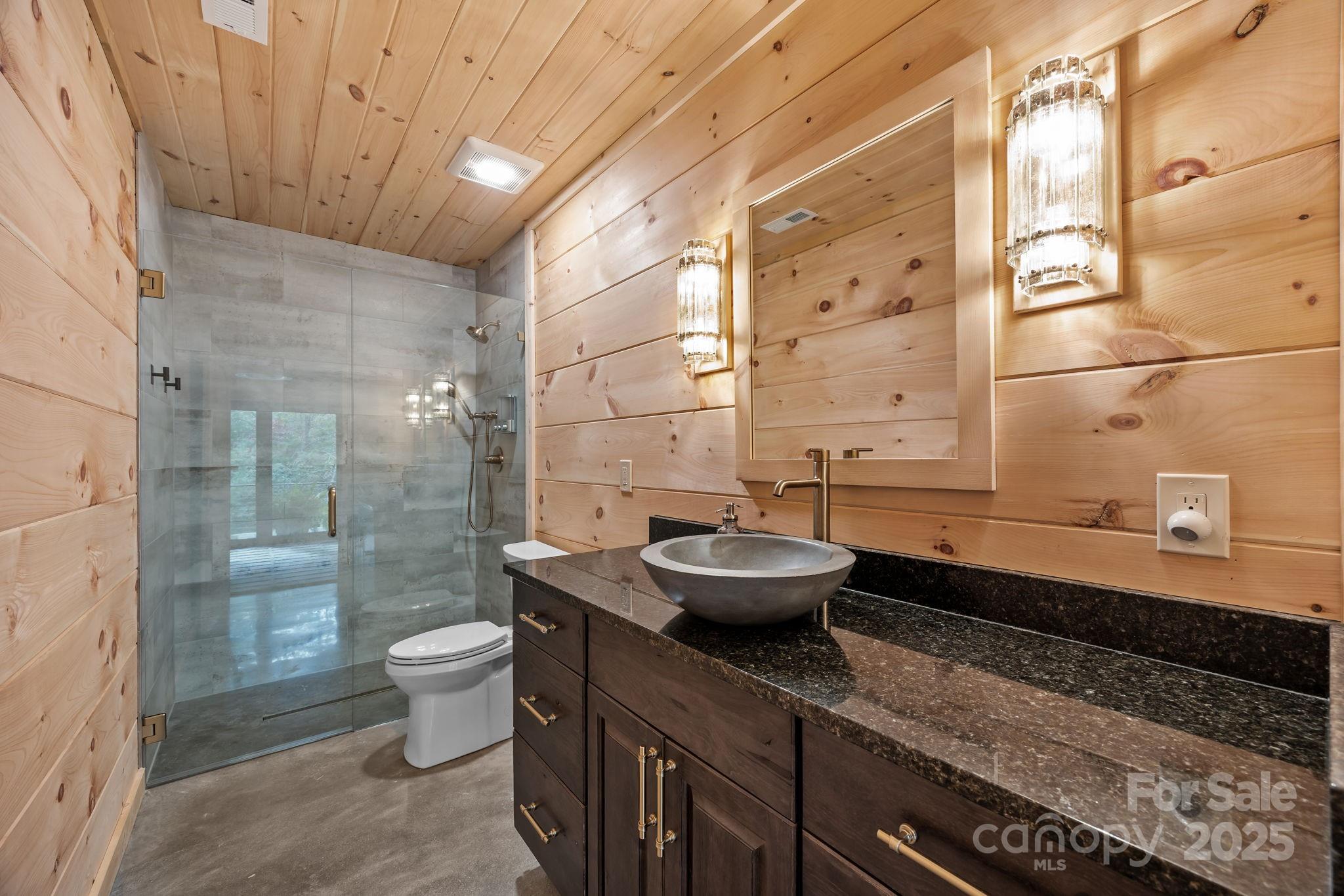 91 Boone Cove Road Zirconia, NC 28790 - Photo 34 of 48 a bathroom with a granite countertop sink and a mirror