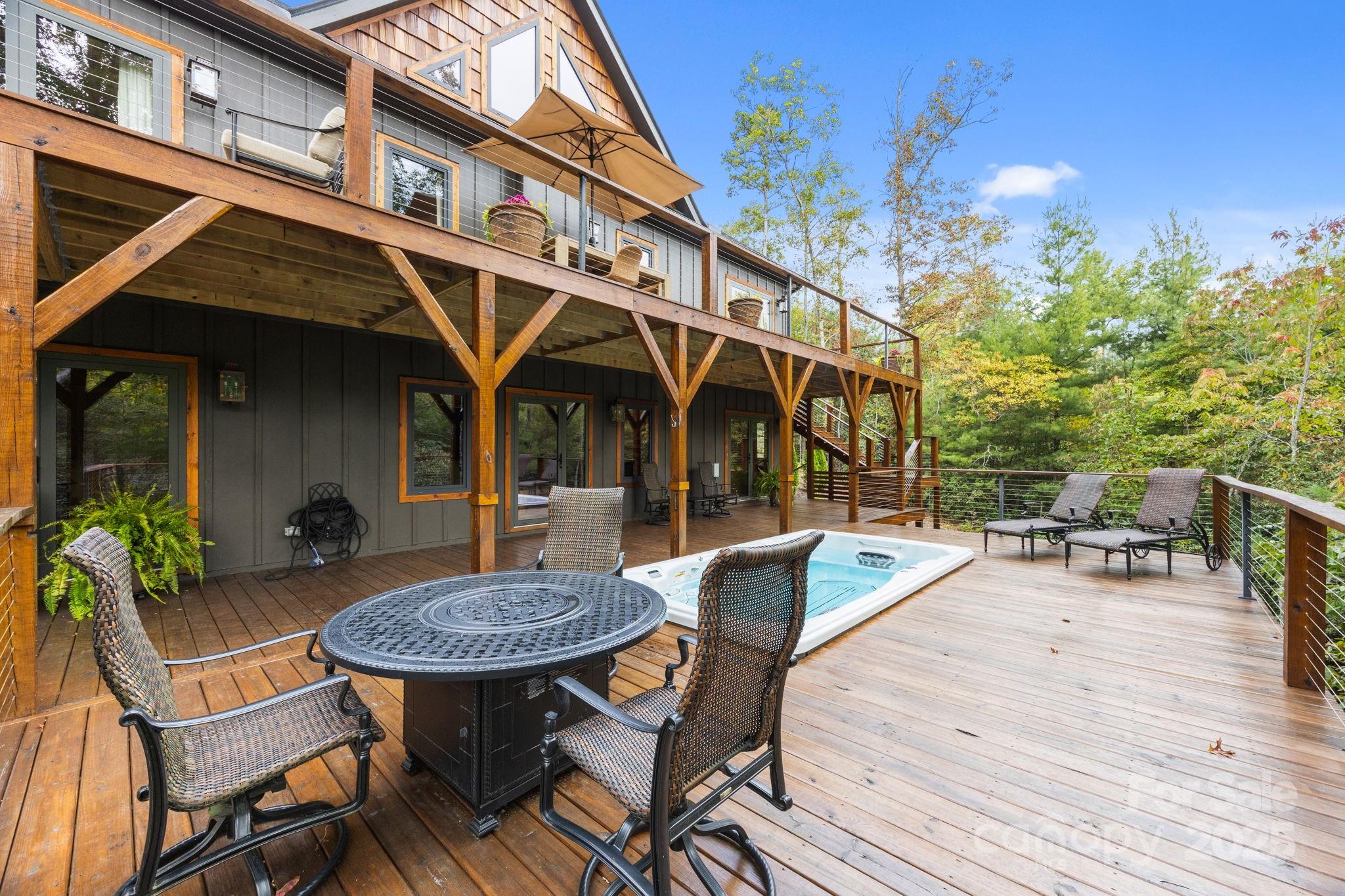 91 Boone Cove Road Zirconia, NC 28790 - Photo 36 of 48 a view of a table and chairs in patio of the house