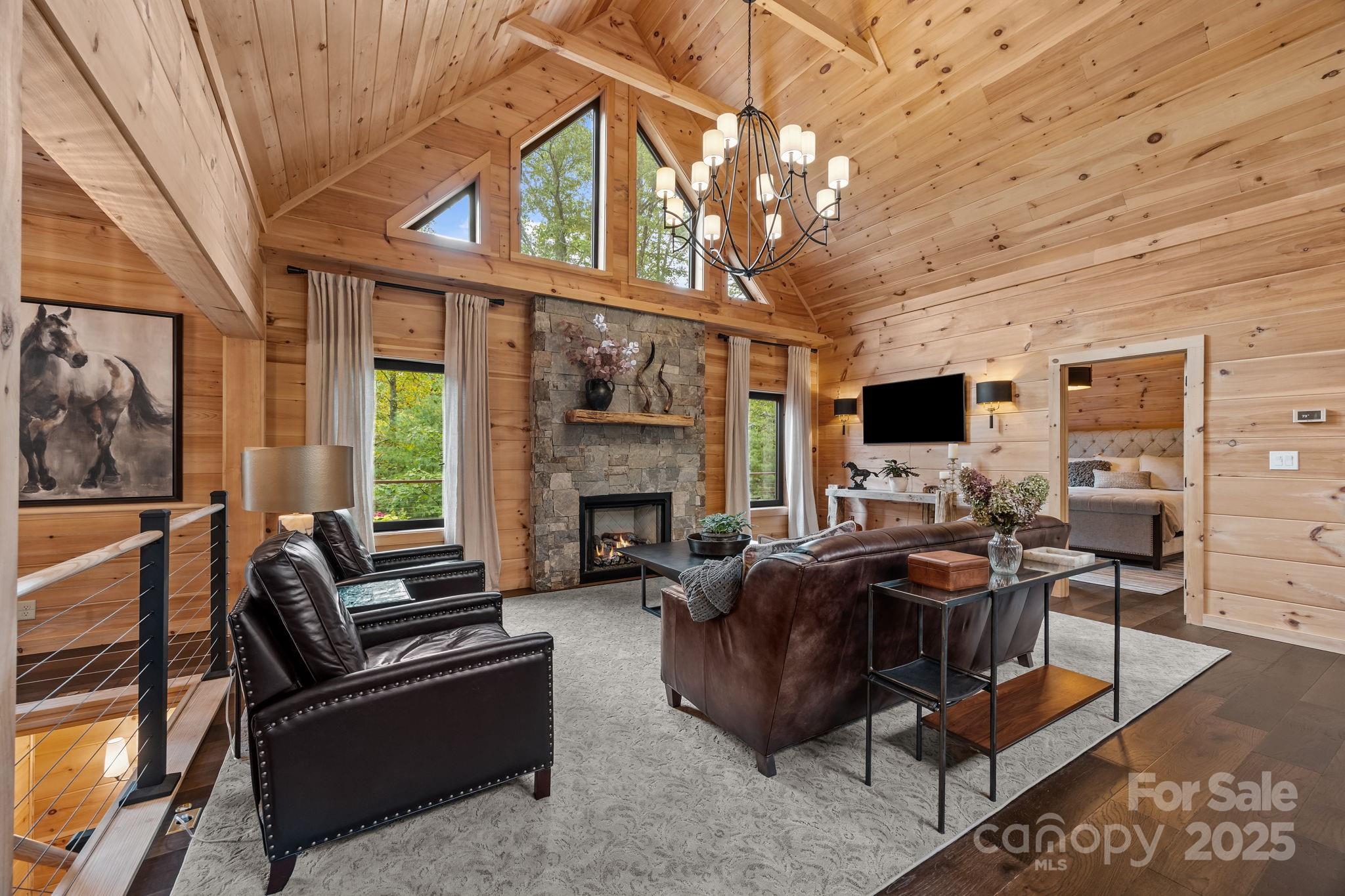 91 Boone Cove Road Zirconia, NC 28790 - Photo 6 of 48 a living room with furniture a fireplace and a flat screen tv