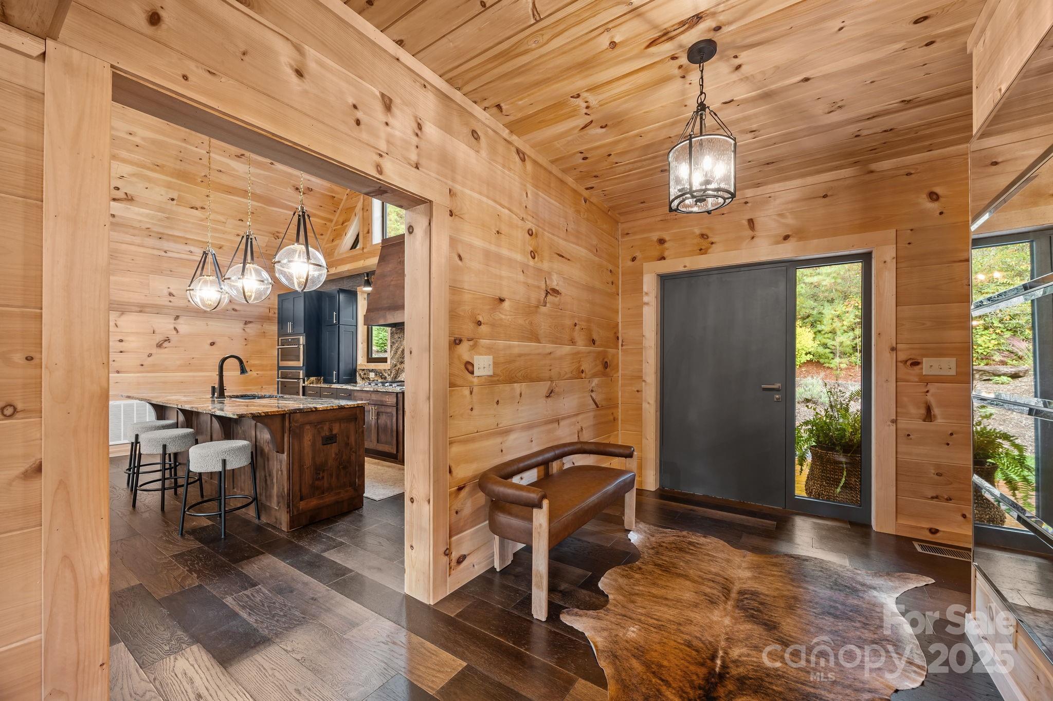 91 Boone Cove Road Zirconia, NC 28790 - Photo 8 of 48 a view of a dining room with furniture window and wooden floor