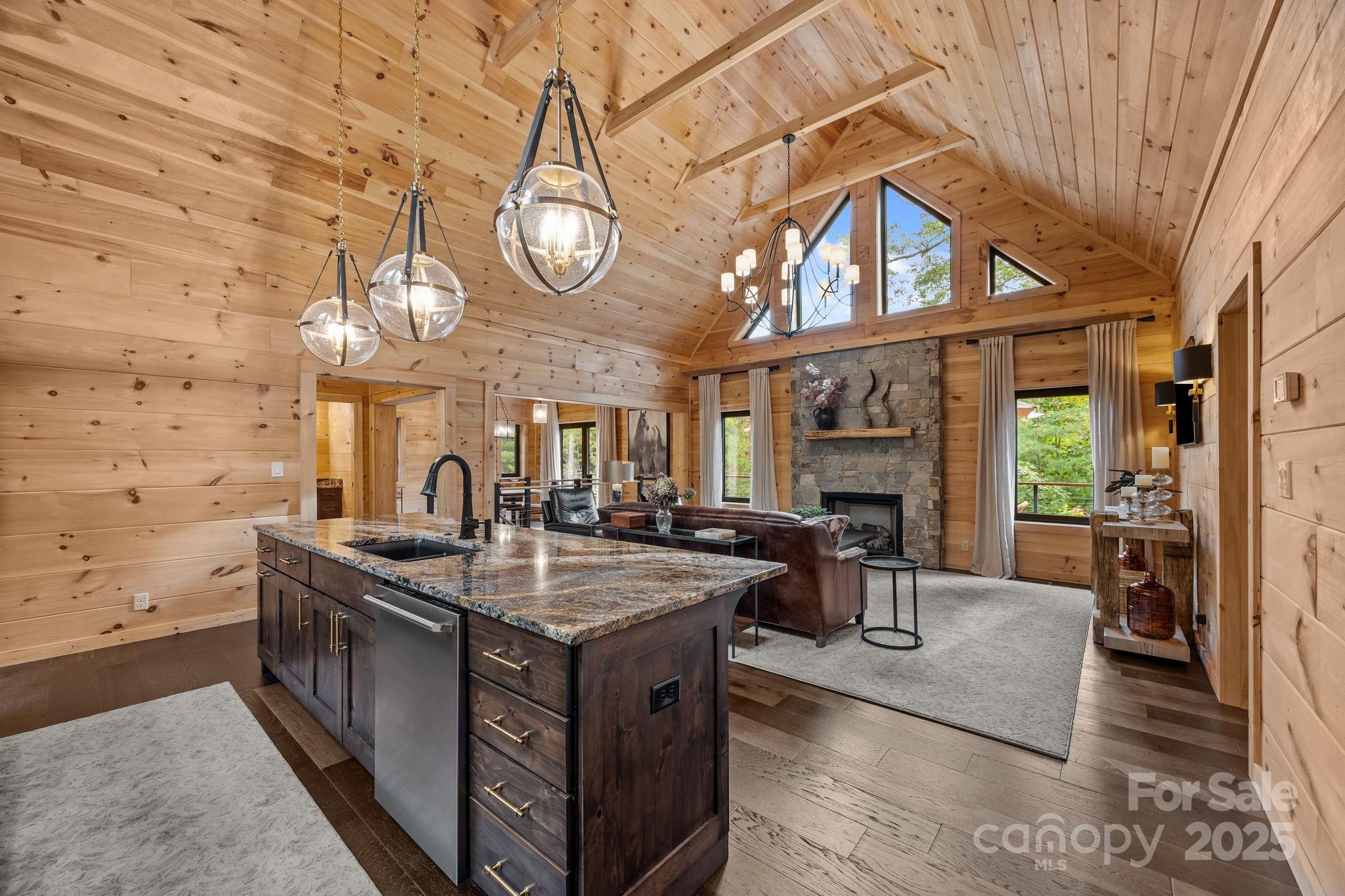 91 Boone Cove Road Zirconia, NC 28790 - Photo 9 of 48 a view of a kitchen with a sink and dishwasher a stove with wooden floor