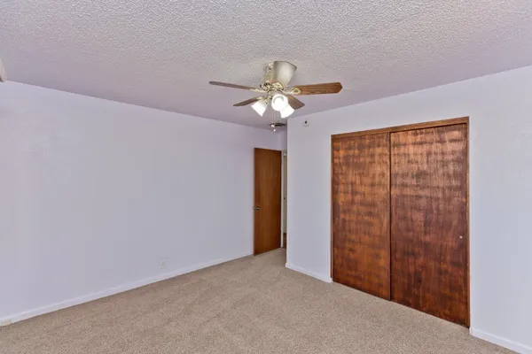 a view of a livingroom with a chandelier fan
