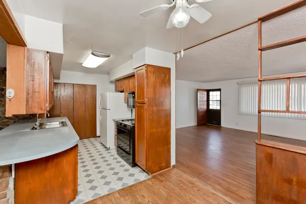 a view of a refrigerator in kitchen and wooden floor