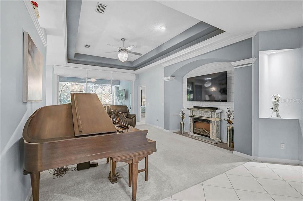 103 Bishopscourt Road Osprey, FL 34229 - Photo 7 of 55 a living room with furniture and a flat screen tv