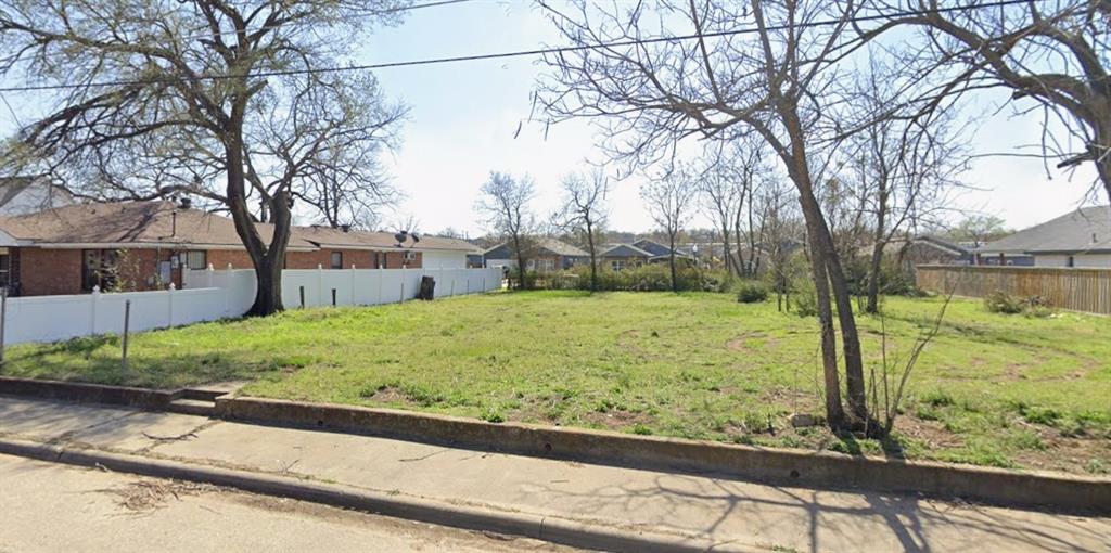 a view of a yard with large trees