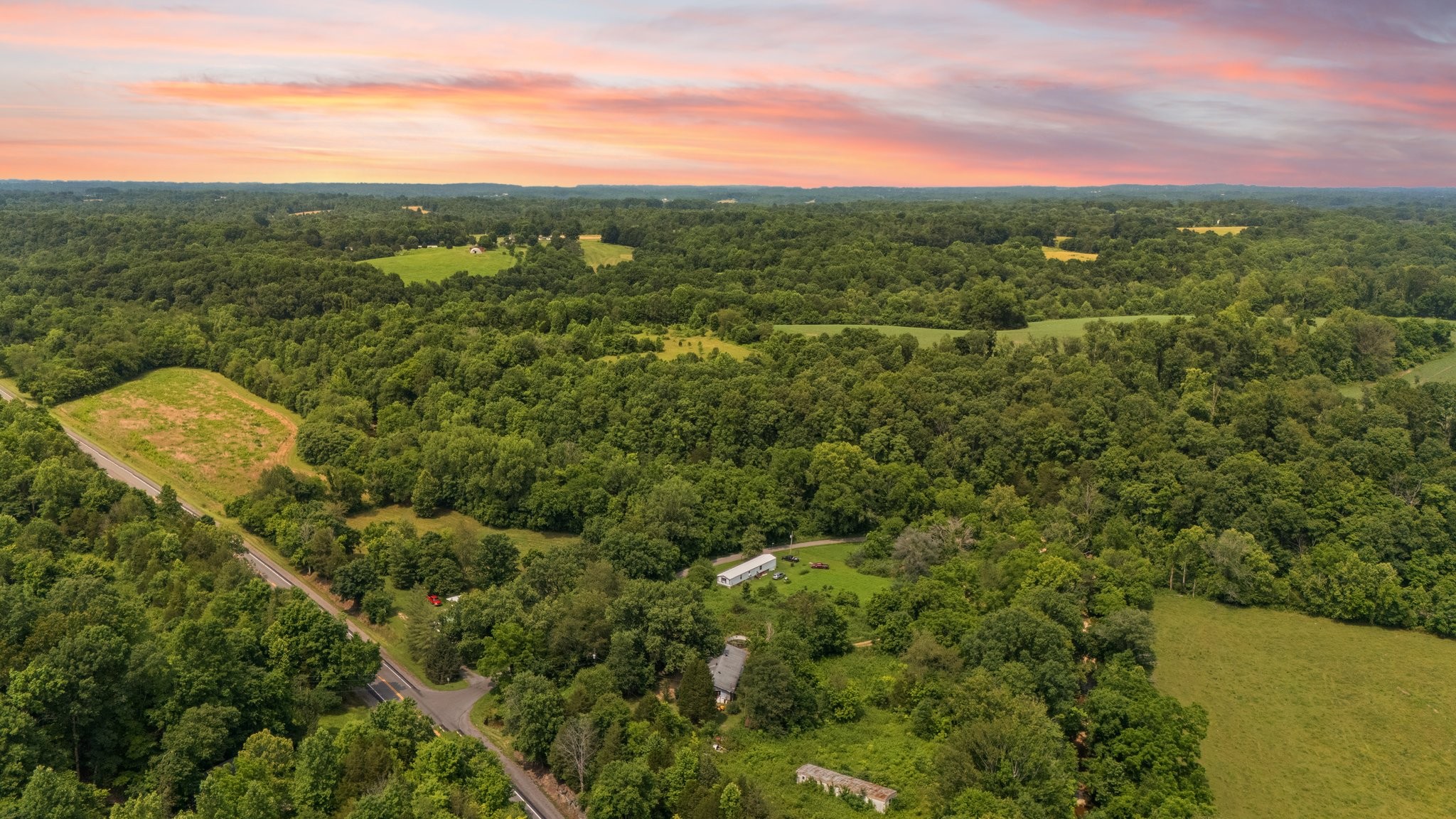42 Oneal Road Adolphus, KY 42120 - Photo 2 of 28 a view of a city with lush green forest