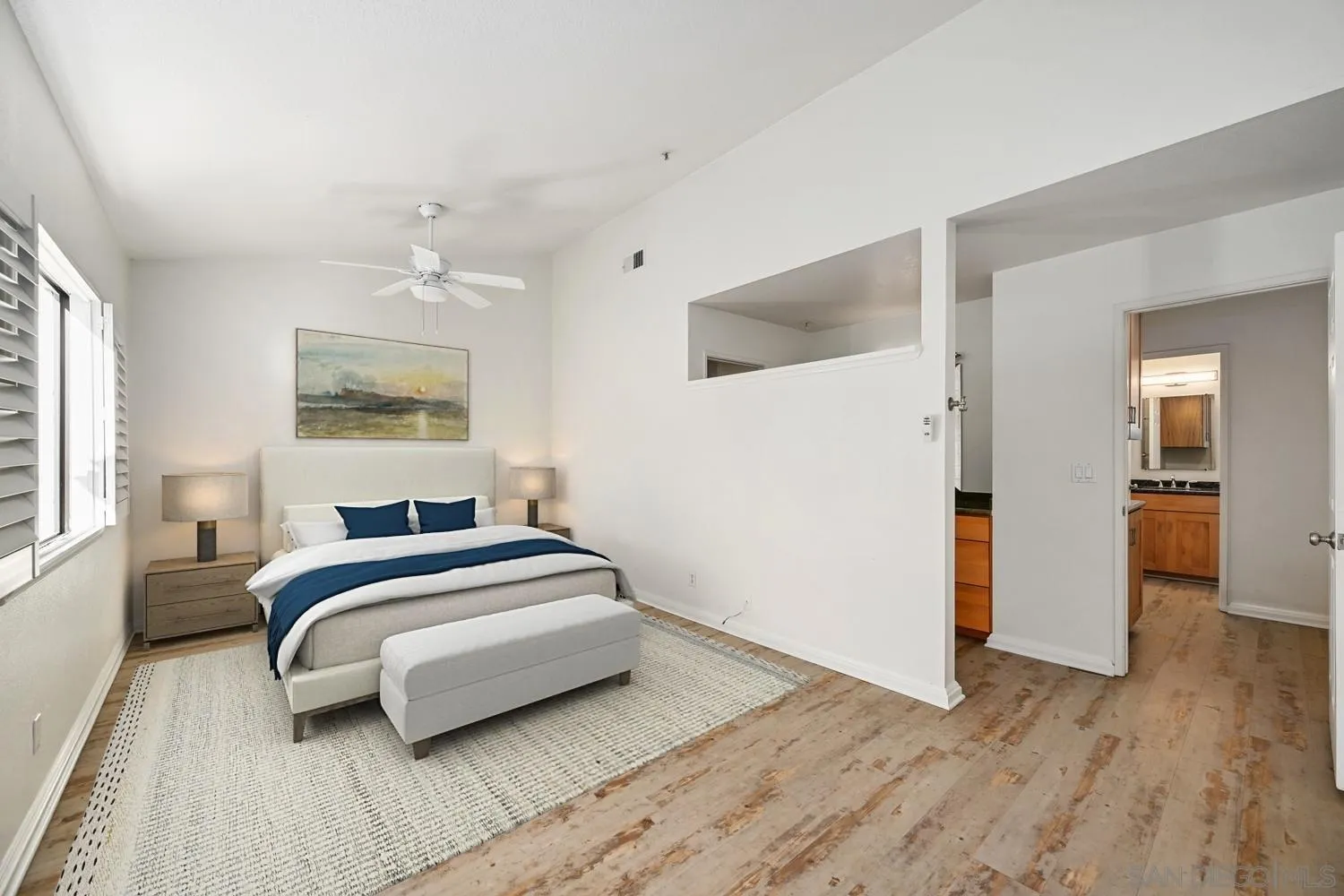 1680 North Coast Highway 101, Unit 30 Encinitas, CA 92024 - Photo 16 of 41 a bedroom with a bed and wooden floor