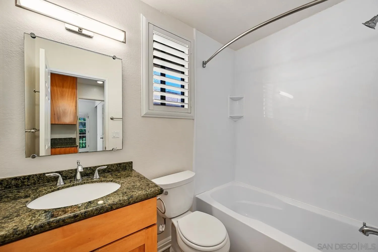 1680 North Coast Highway 101, Unit 30 Encinitas, CA 92024 - Photo 24 of 41 a bathroom with a granite countertop sink toilet and shower