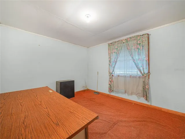 a bedroom with a bed and a table