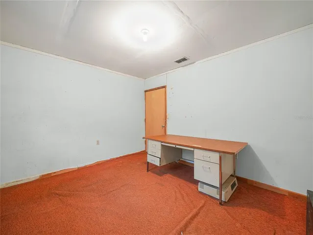 a room with a desk and a window