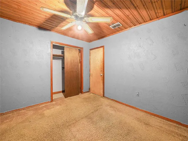 a view of a big room with a ceiling fan