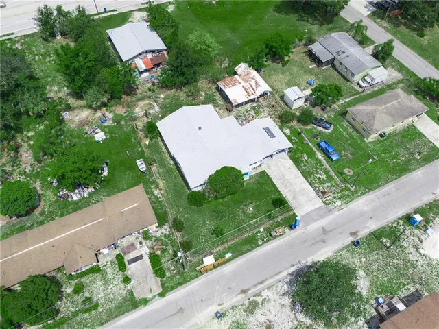 an aerial view of a house with garden space and street view