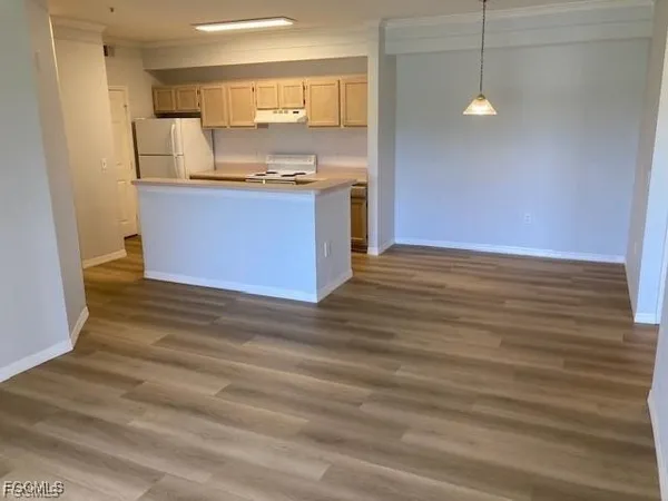 a view with granite countertop kitchen island a sink stainless steel appliances and cabinets