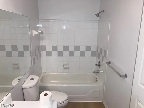 a bathroom with a bathtub toilet and shower