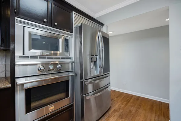 a metallic refrigerator freezer sitting in a kitchen