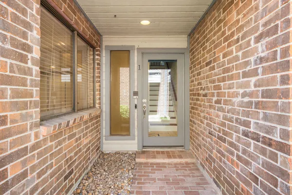a view of a brick house with a glass door