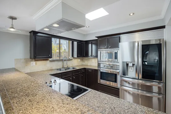 a kitchen with stainless steel appliances granite countertop a stove and a sink