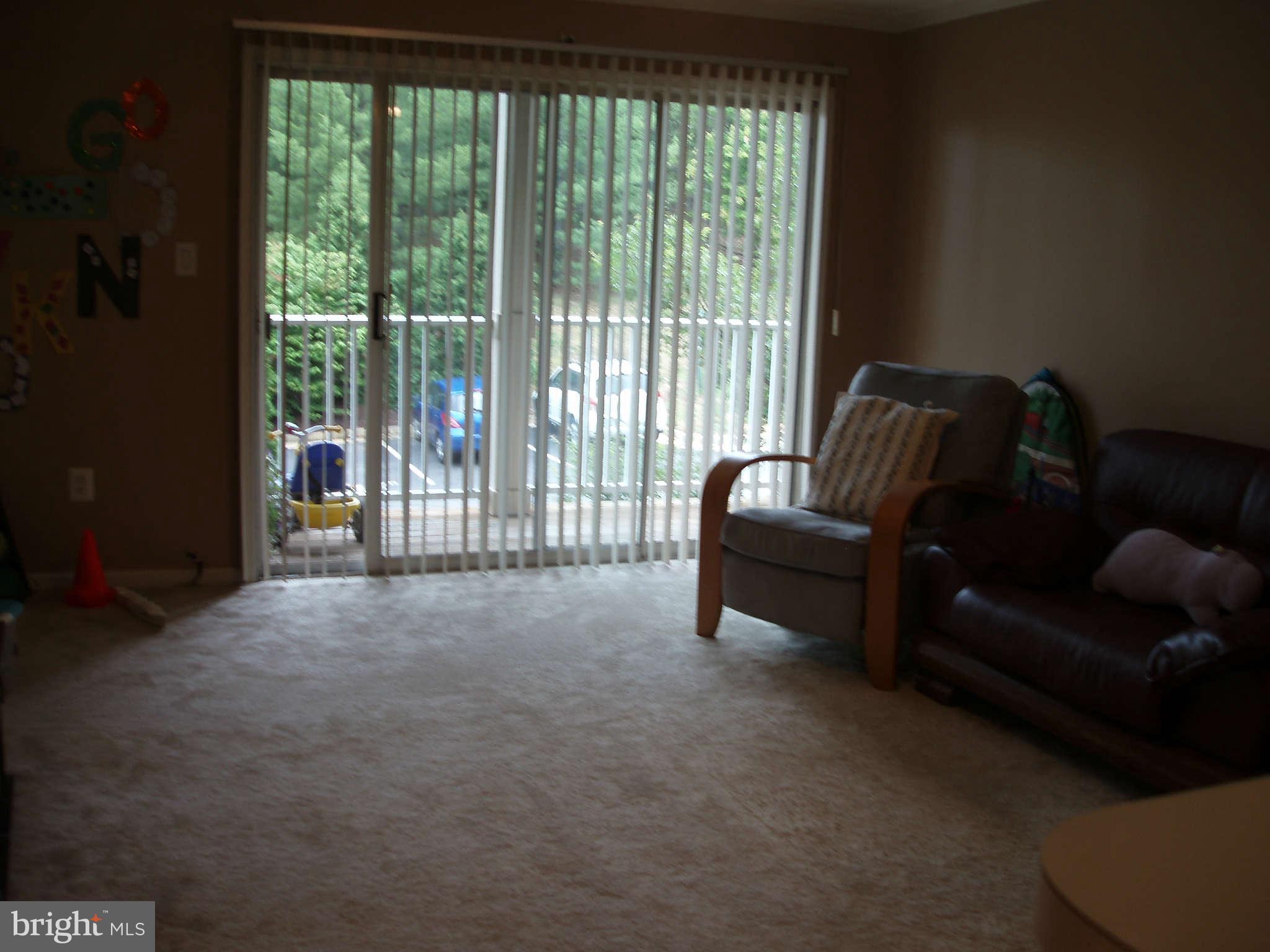 1049 Gardenview Loop, Unit 301 Woodbridge, VA 22191 - Photo 2 of 16 a living room with furniture and a floor to ceiling window