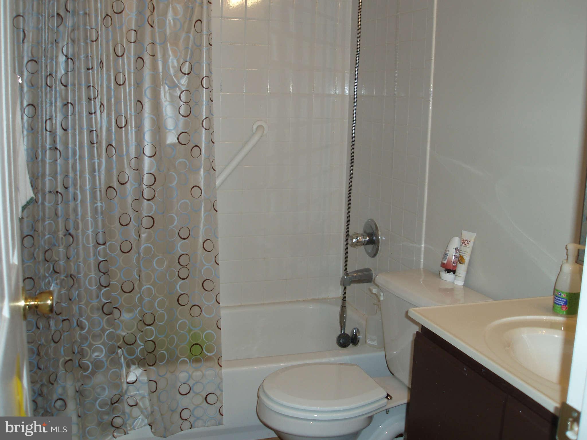 1049 Gardenview Loop, Unit 301 Woodbridge, VA 22191 - Photo 13 of 16 a bathroom with a sink a toilet and shower