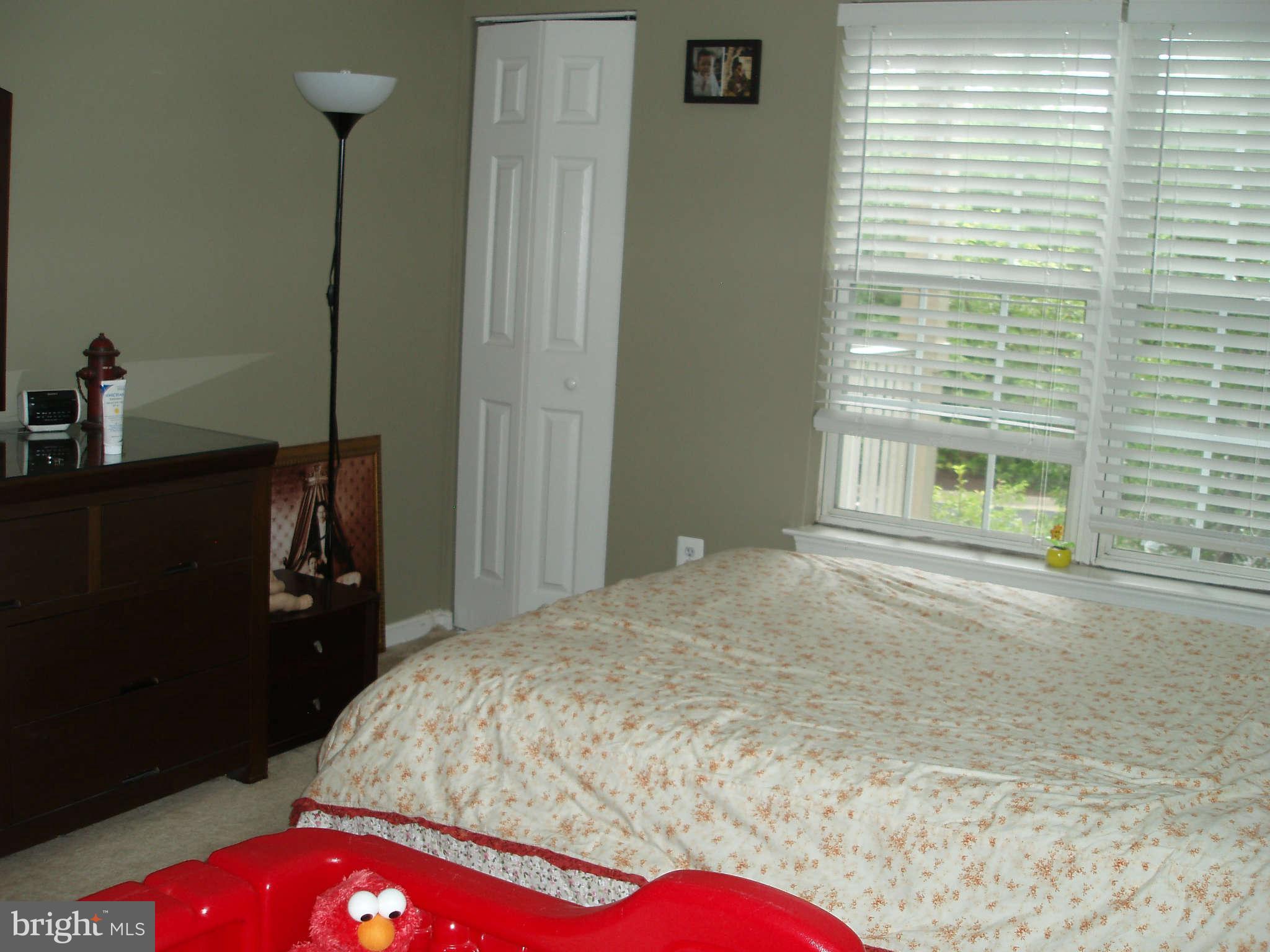 1049 Gardenview Loop, Unit 301 Woodbridge, VA 22191 - Photo 14 of 16 a bedroom with a bed and a window