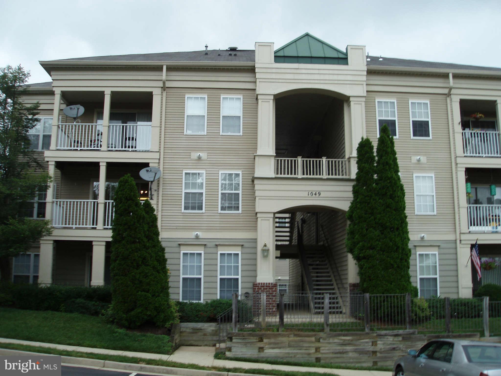 1049 Gardenview Loop, Unit 301 Woodbridge, VA 22191 - Photo 16 of 16 a front view of a house with a yard