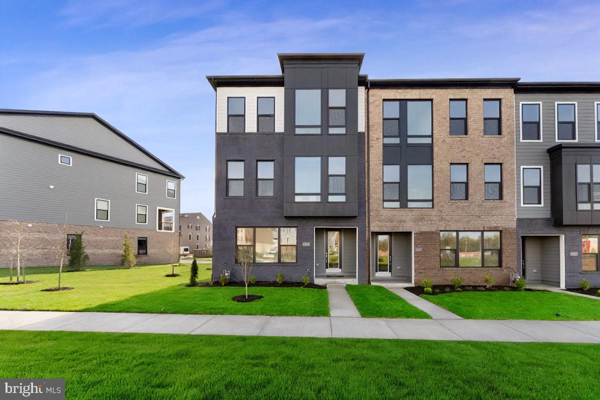 a front view of a building with a yard