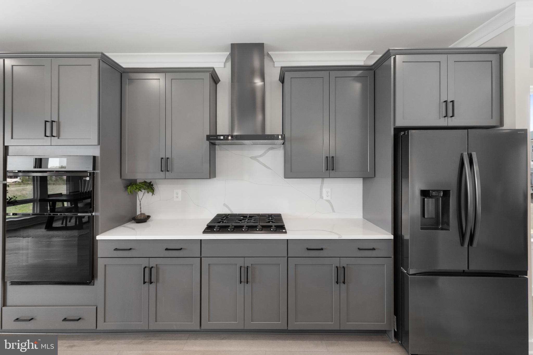 129 Summit Point Boulevard, Unit 11J Bowie, MD 20716 - Photo 12 of 45 a kitchen with stainless steel appliances white cabinets and a refrigerator