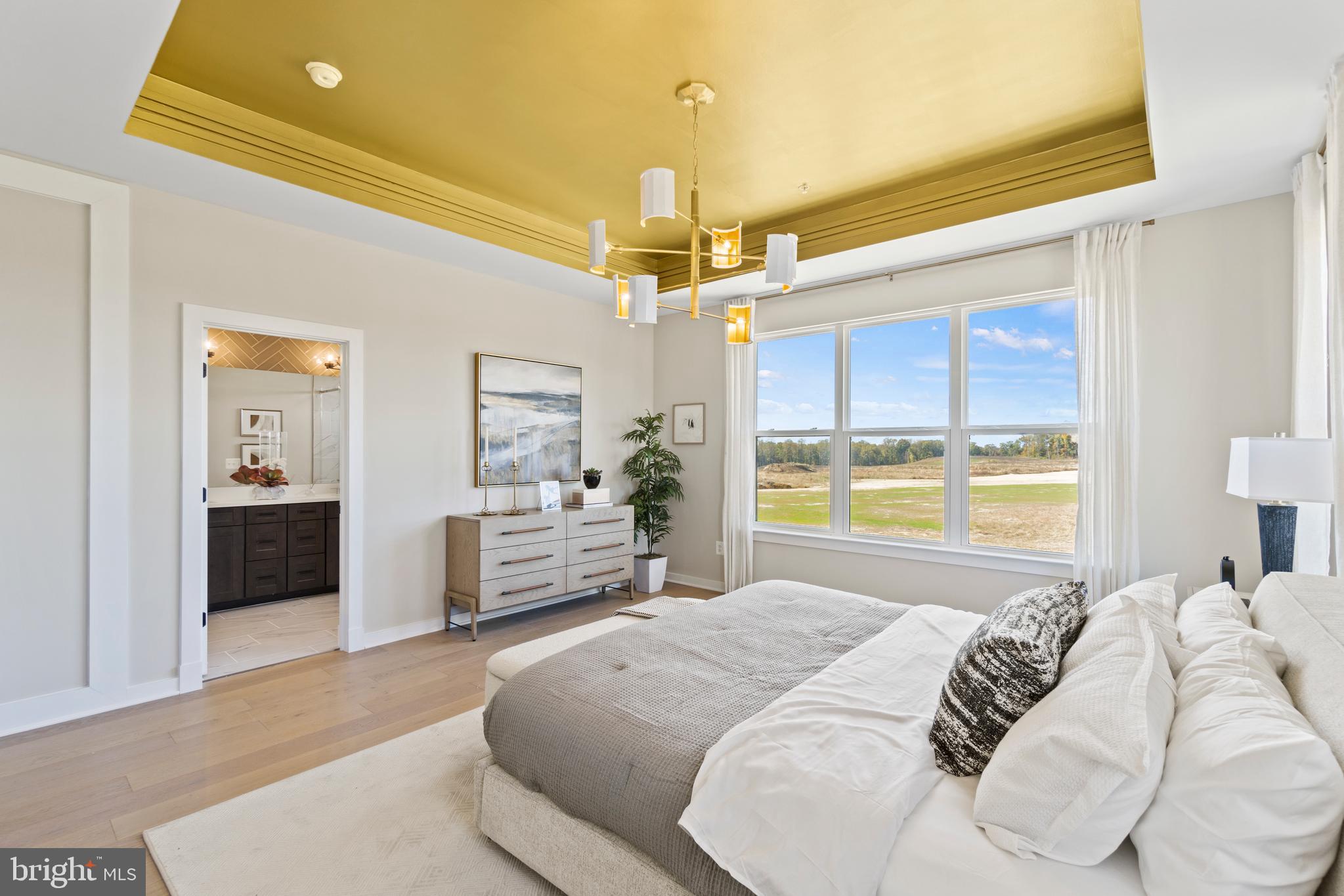 129 Summit Point Boulevard, Unit 11J Bowie, MD 20716 - Photo 13 of 45 a bedroom with a large bed and a chandelier