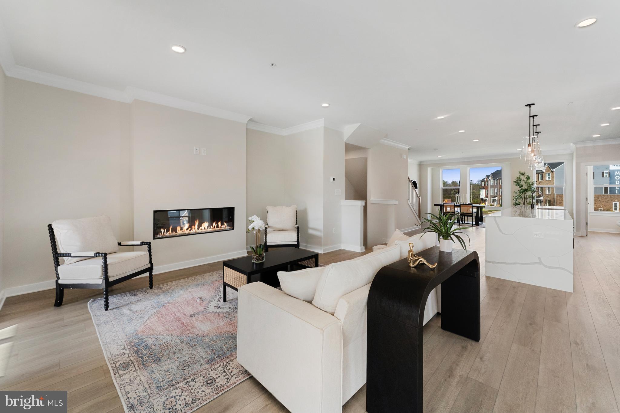 129 Summit Point Boulevard, Unit 11J Bowie, MD 20716 - Photo 16 of 45 a living room with furniture and a wooden floor