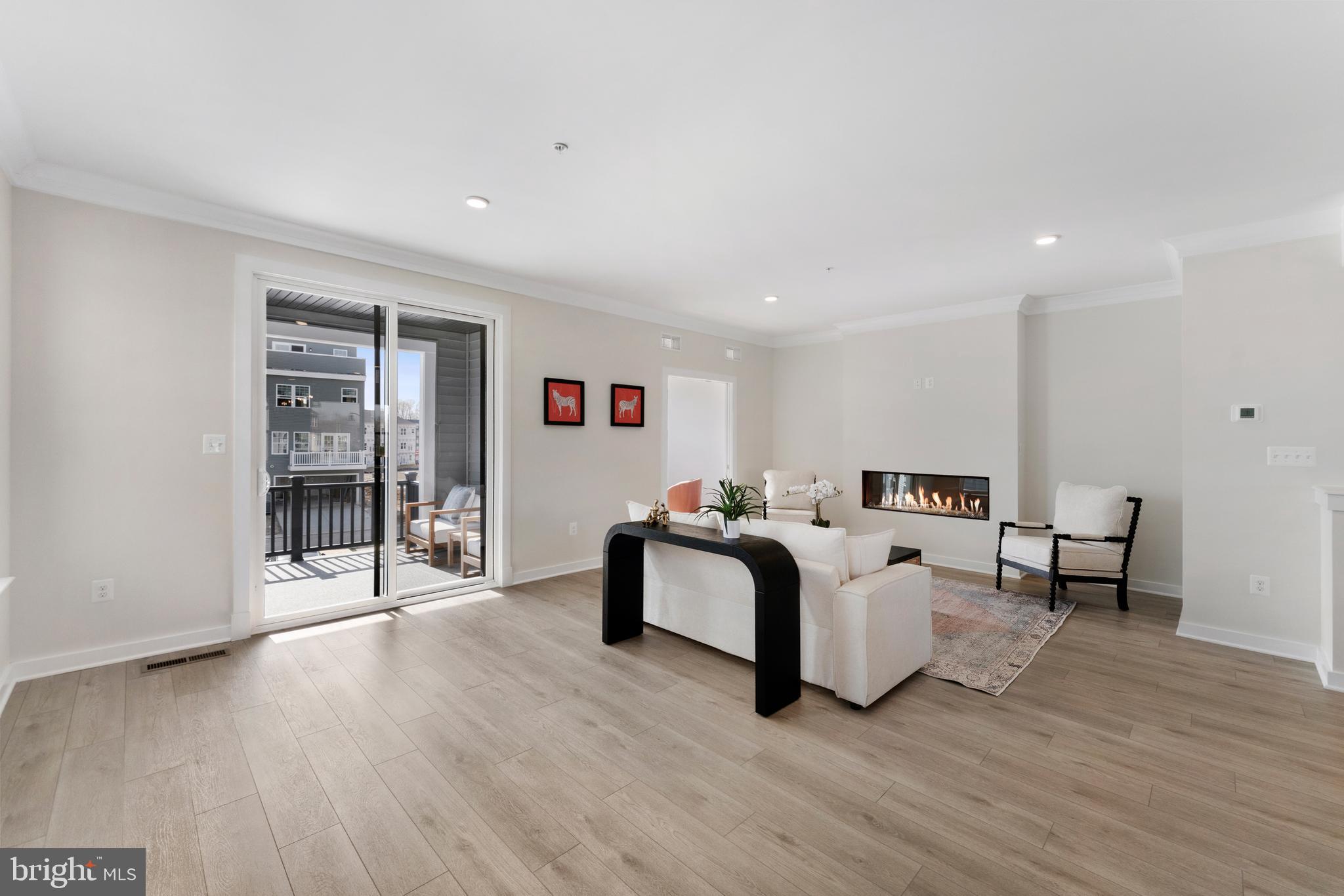 129 Summit Point Boulevard, Unit 11J Bowie, MD 20716 - Photo 18 of 45 a living room with furniture and a wooden floor