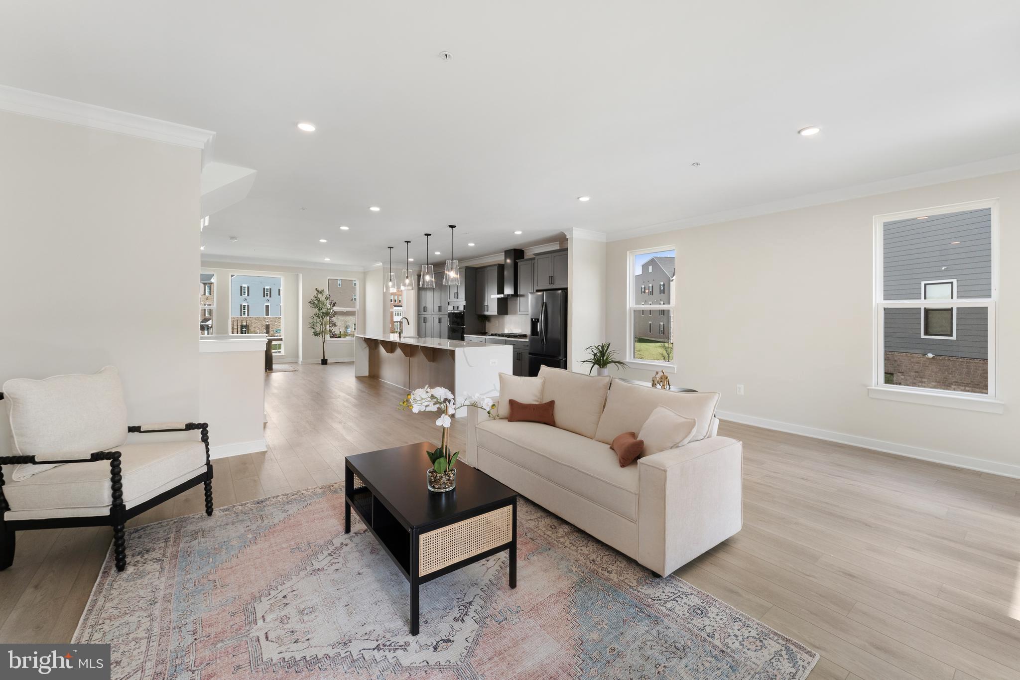129 Summit Point Boulevard, Unit 11J Bowie, MD 20716 - Photo 20 of 45 a living room with furniture and a dining table with wooden floor